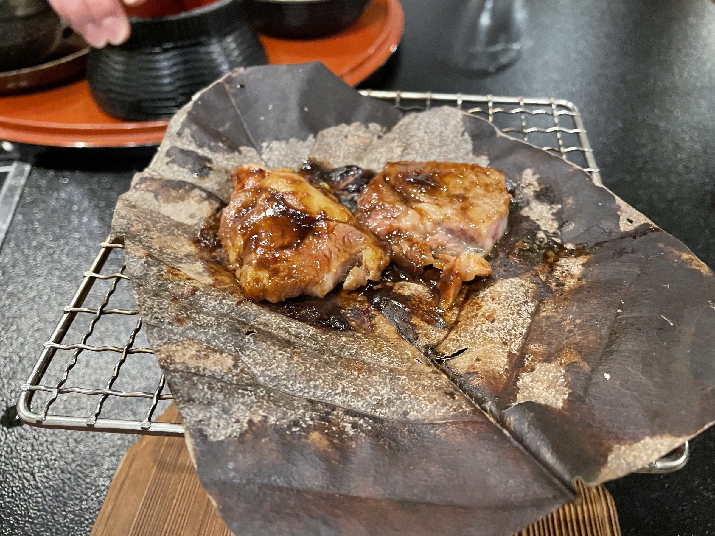The same leaf after grilling, the meat glazed with a dark sauce.