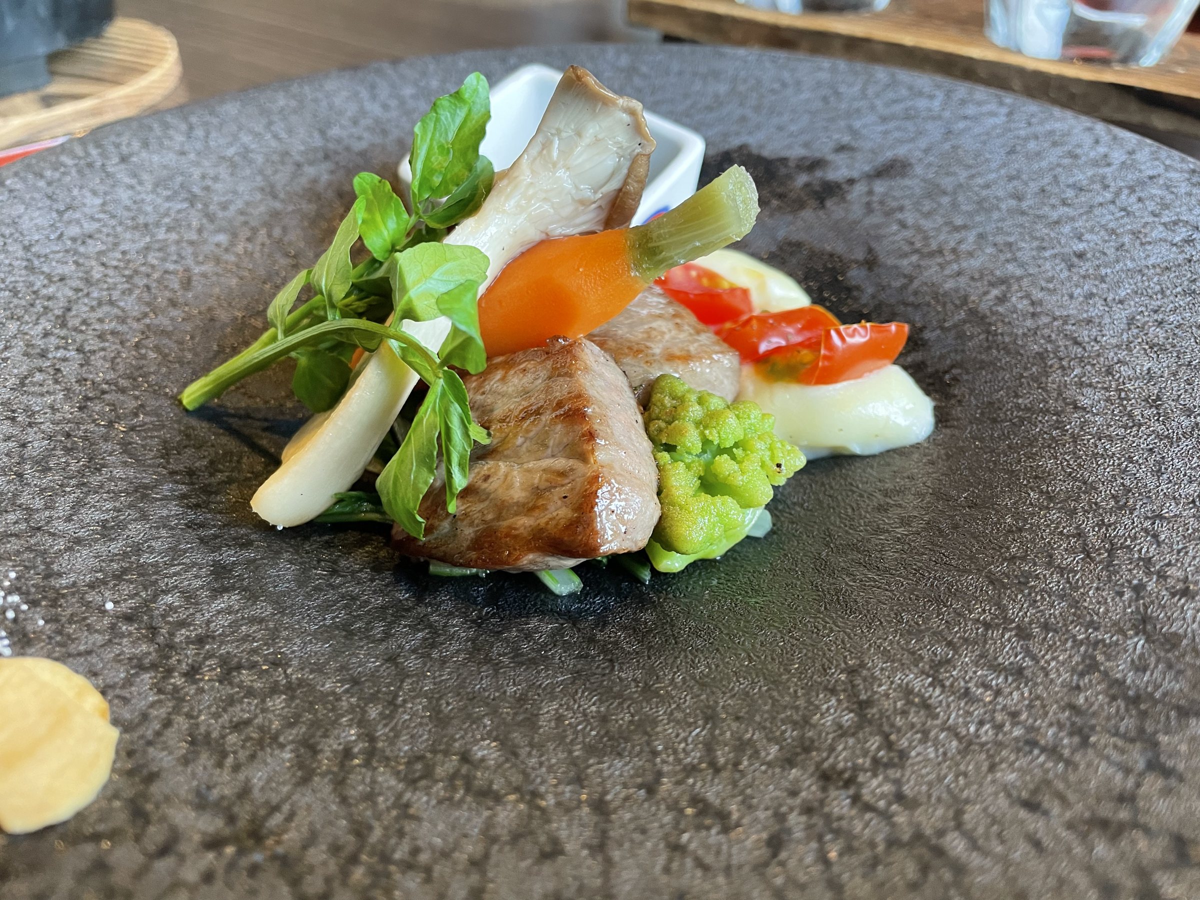 The steak up close, with mushroom, carrot, romanesco and watercress.