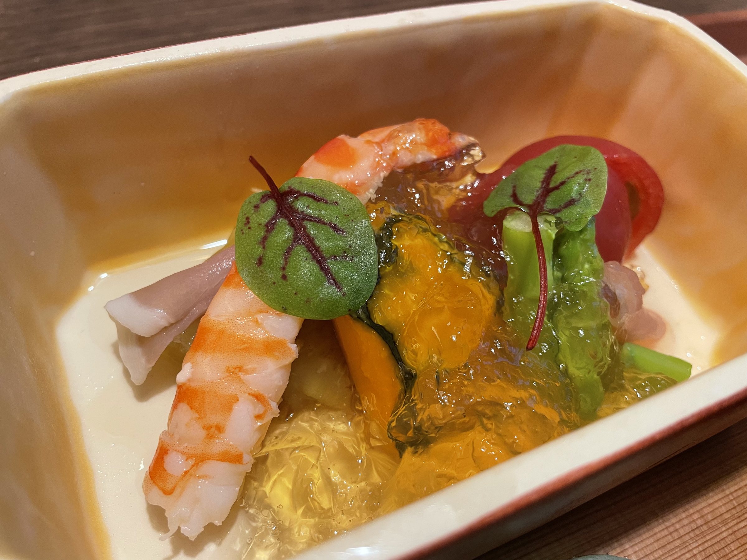 Vegetables and shrimp set in clear jelly.