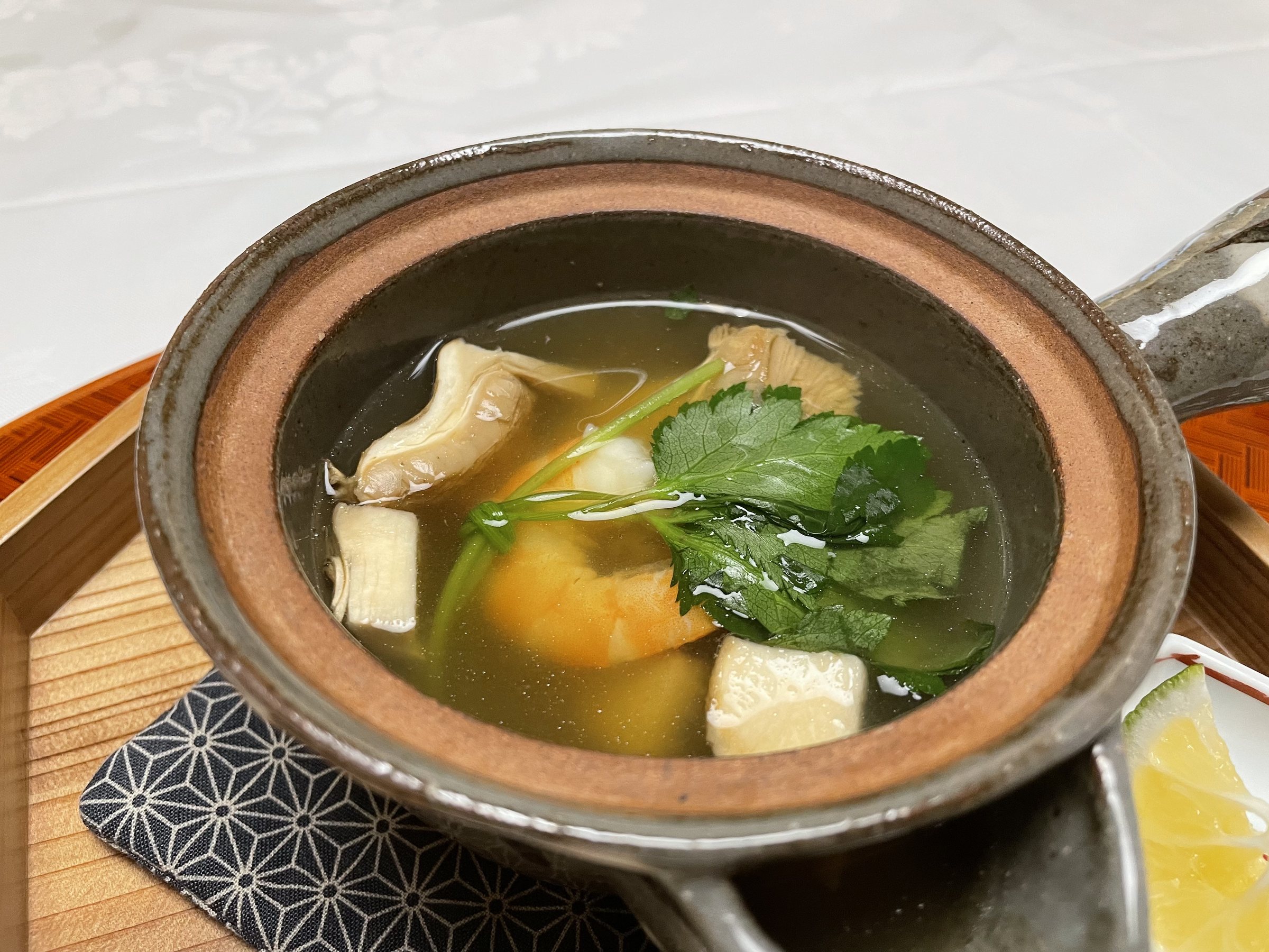 Inside the teapot: prawn, greens and other ingredients in the broth.