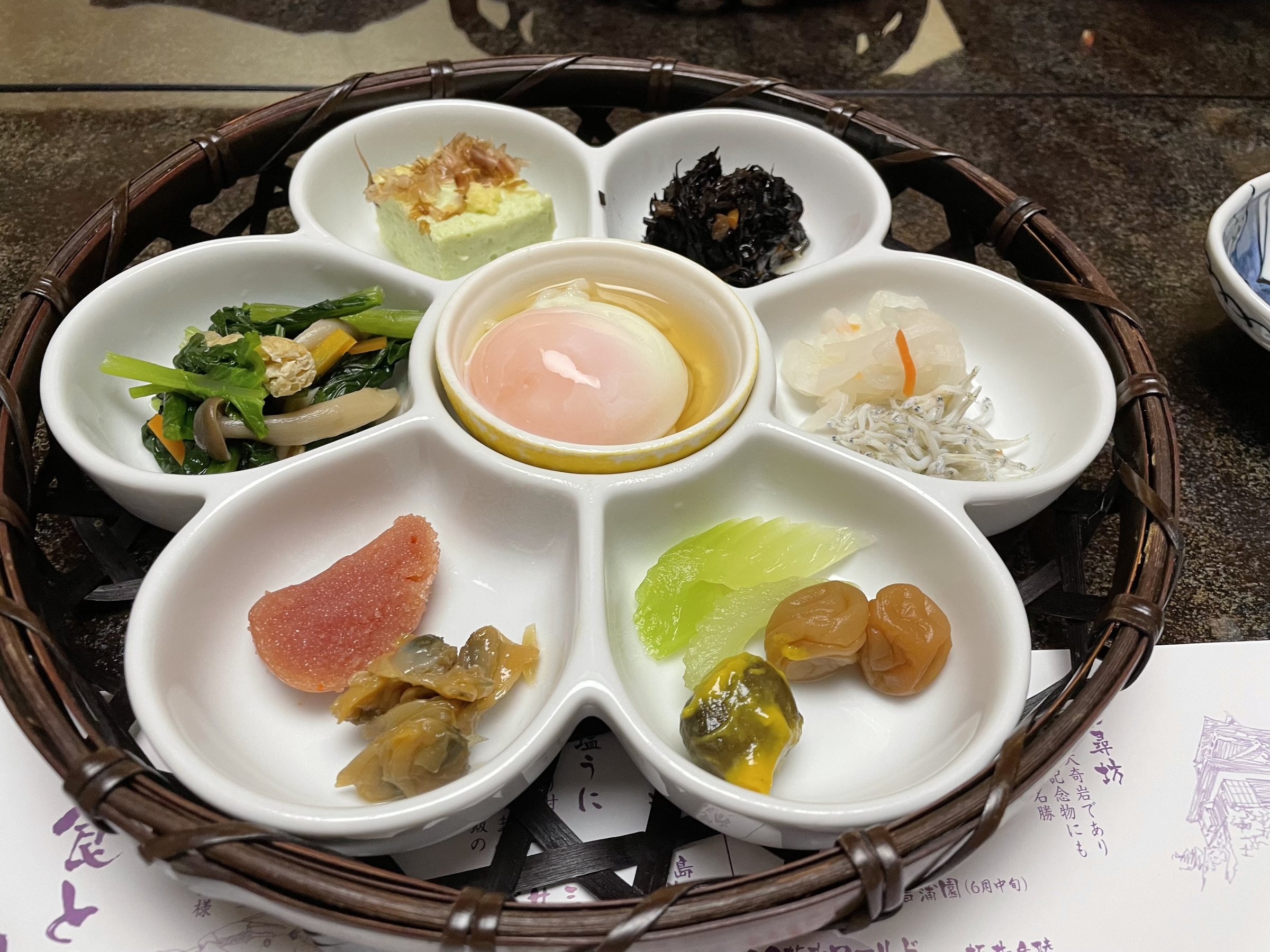 Small side dishes in a flower-shaped tray at breakfast.
