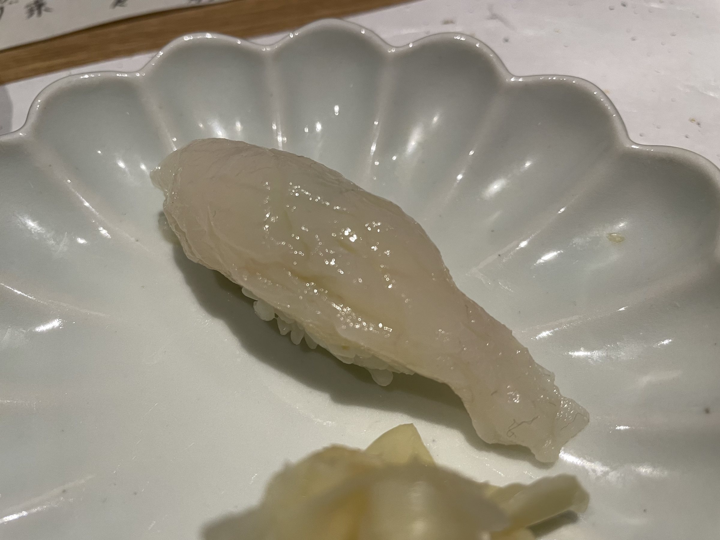 A nigiri of glistening white fish.