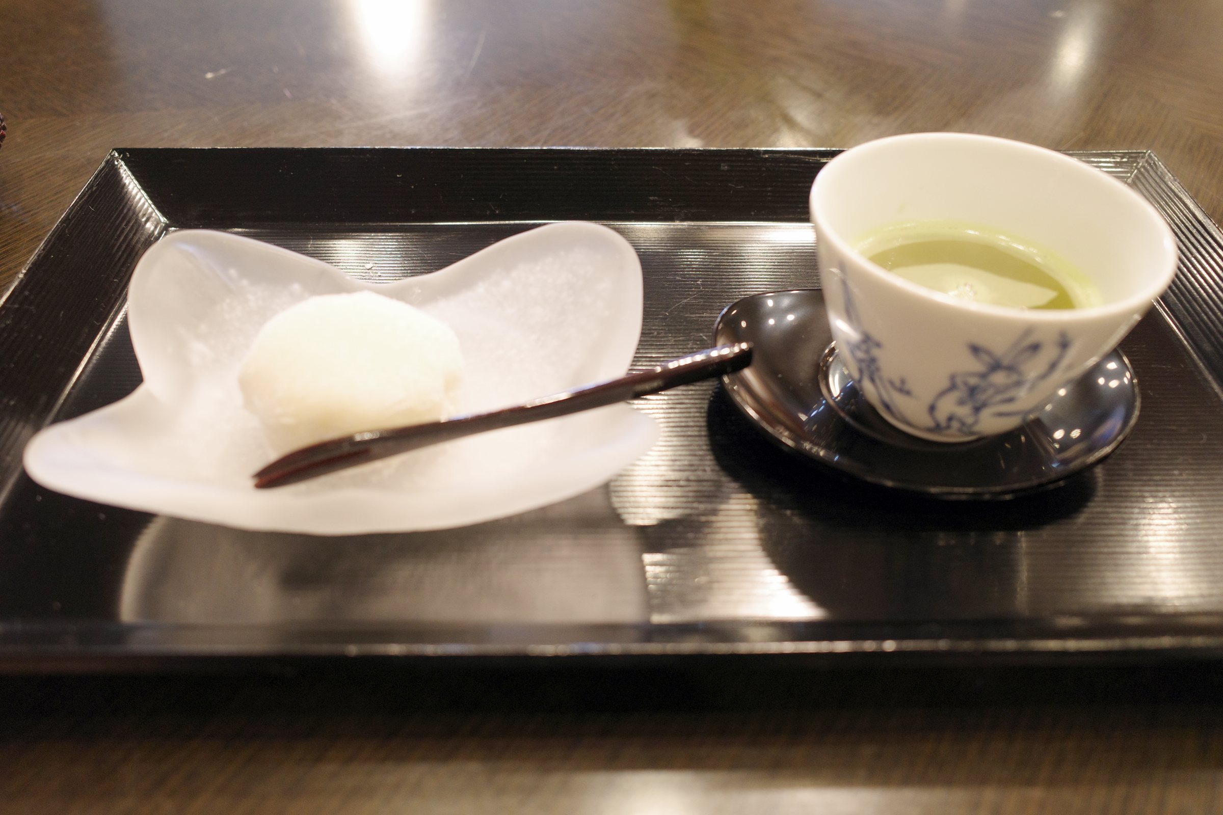 The welcome sweet: a handmade peach daifuku with green tea.