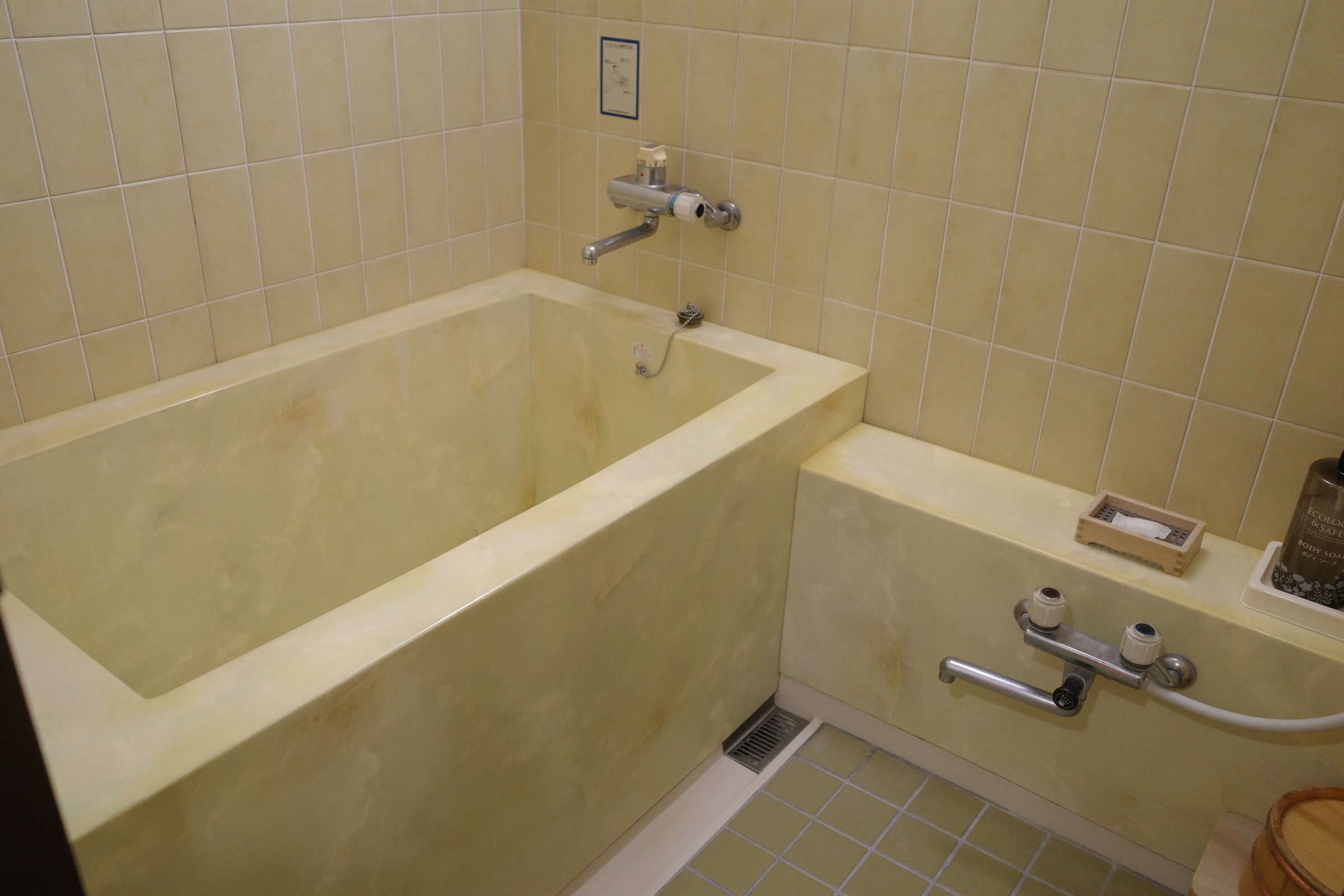 The indoor bathroom, with a tiled tub.