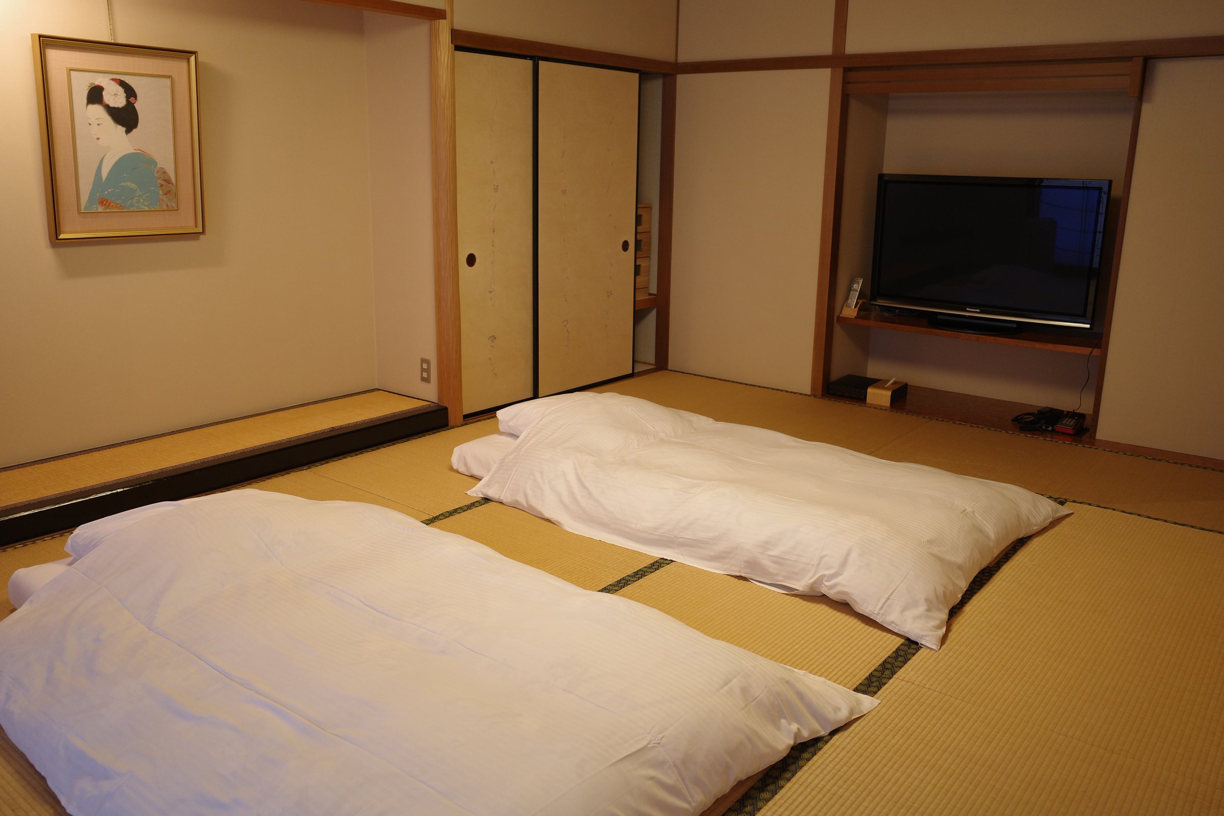 The bedroom from the other side, with a television in the alcove.