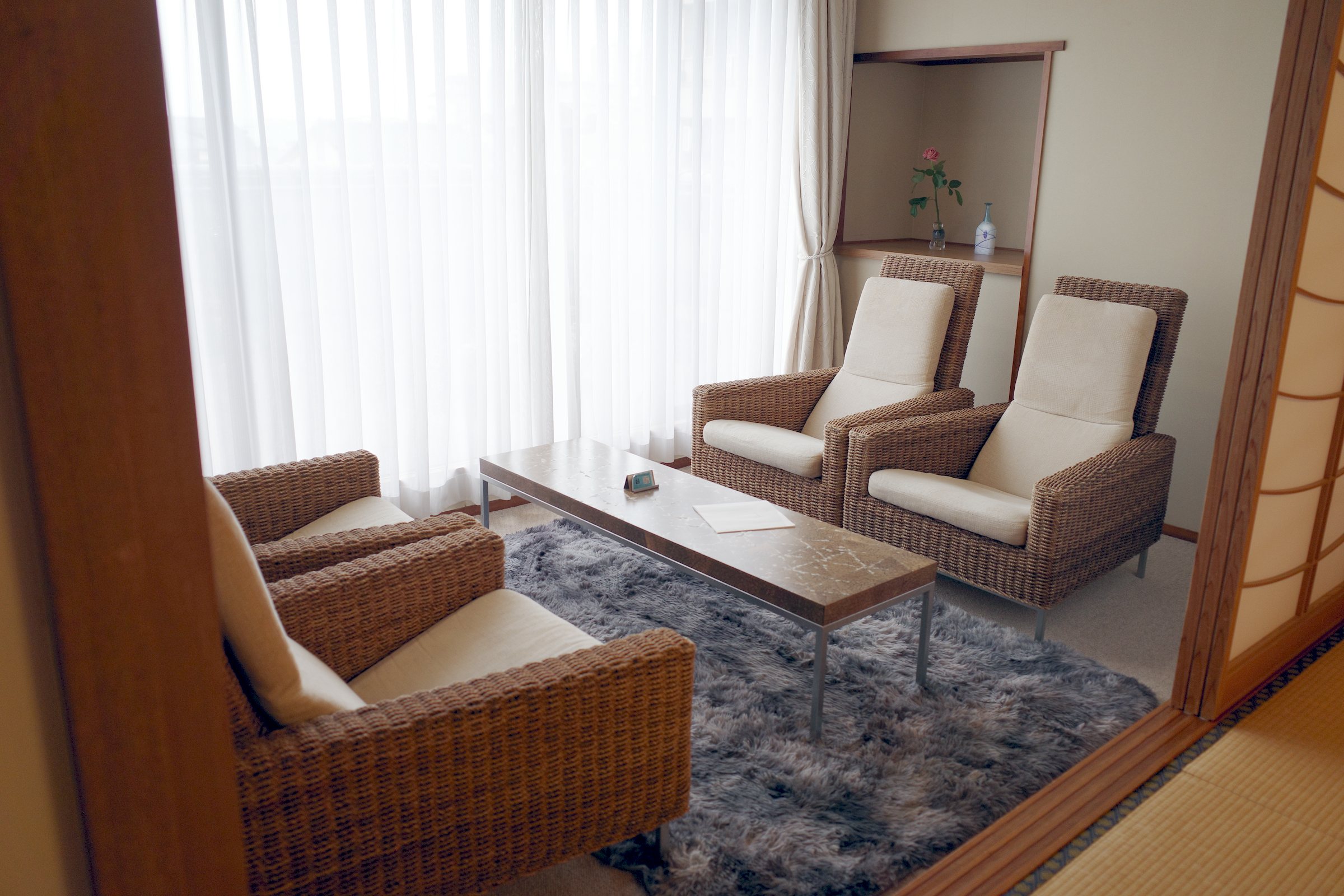 A bright sitting area with armchairs by the window.