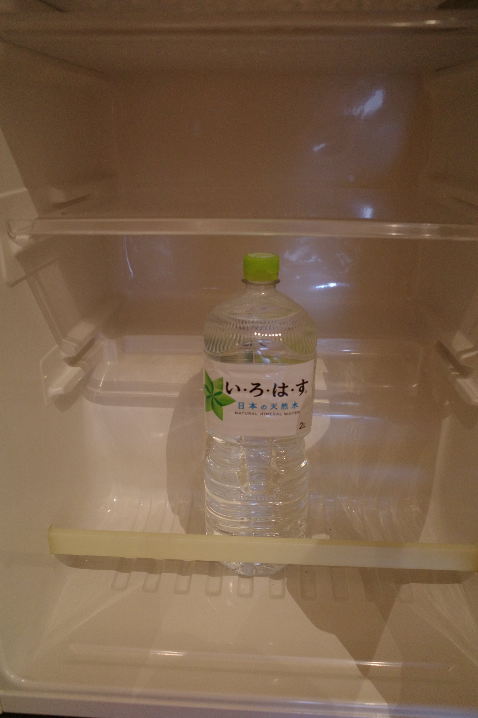 A one-liter bottle of water in the fridge.