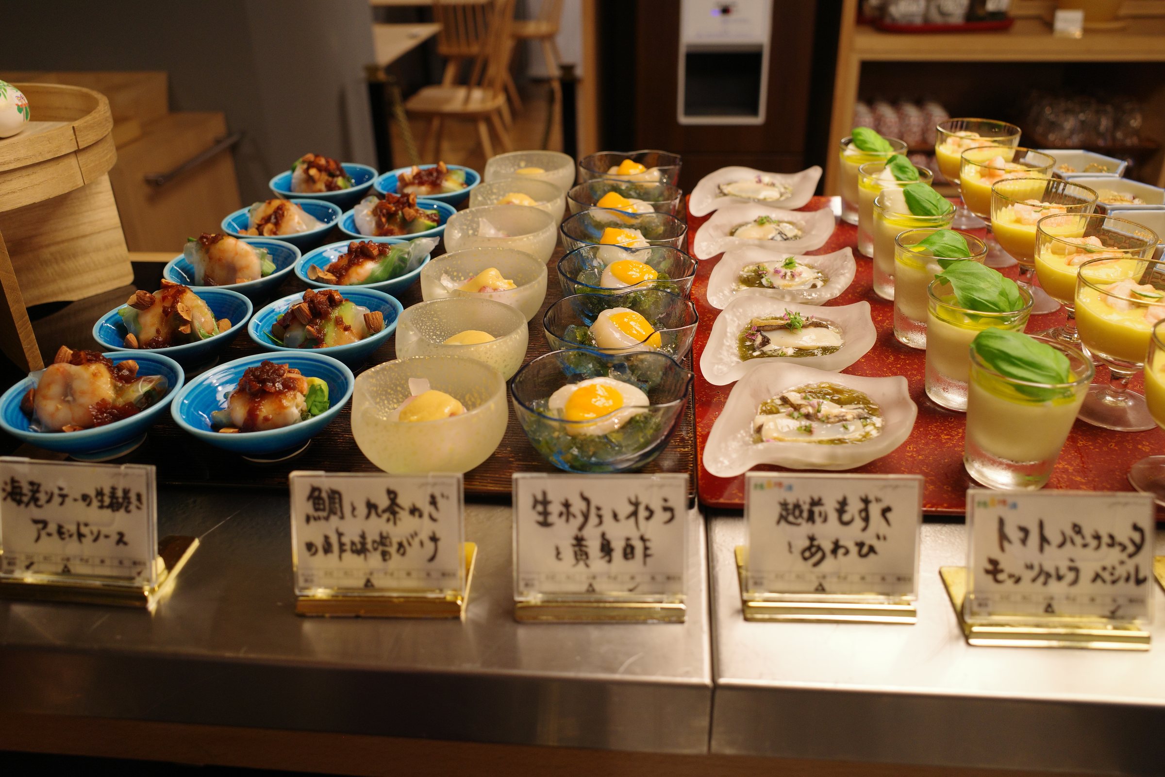 Small dishes with handwritten labels, from mousse to dressed seafood.