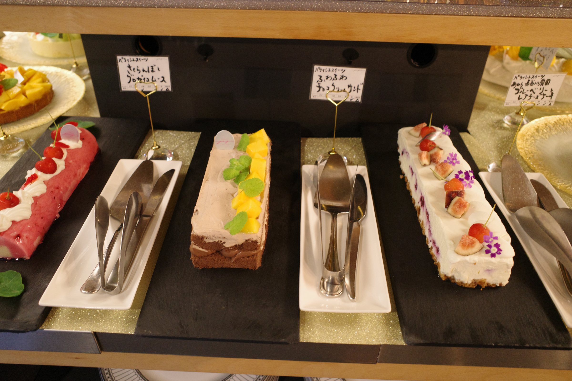 Roll cakes and terrines with handwritten labels.