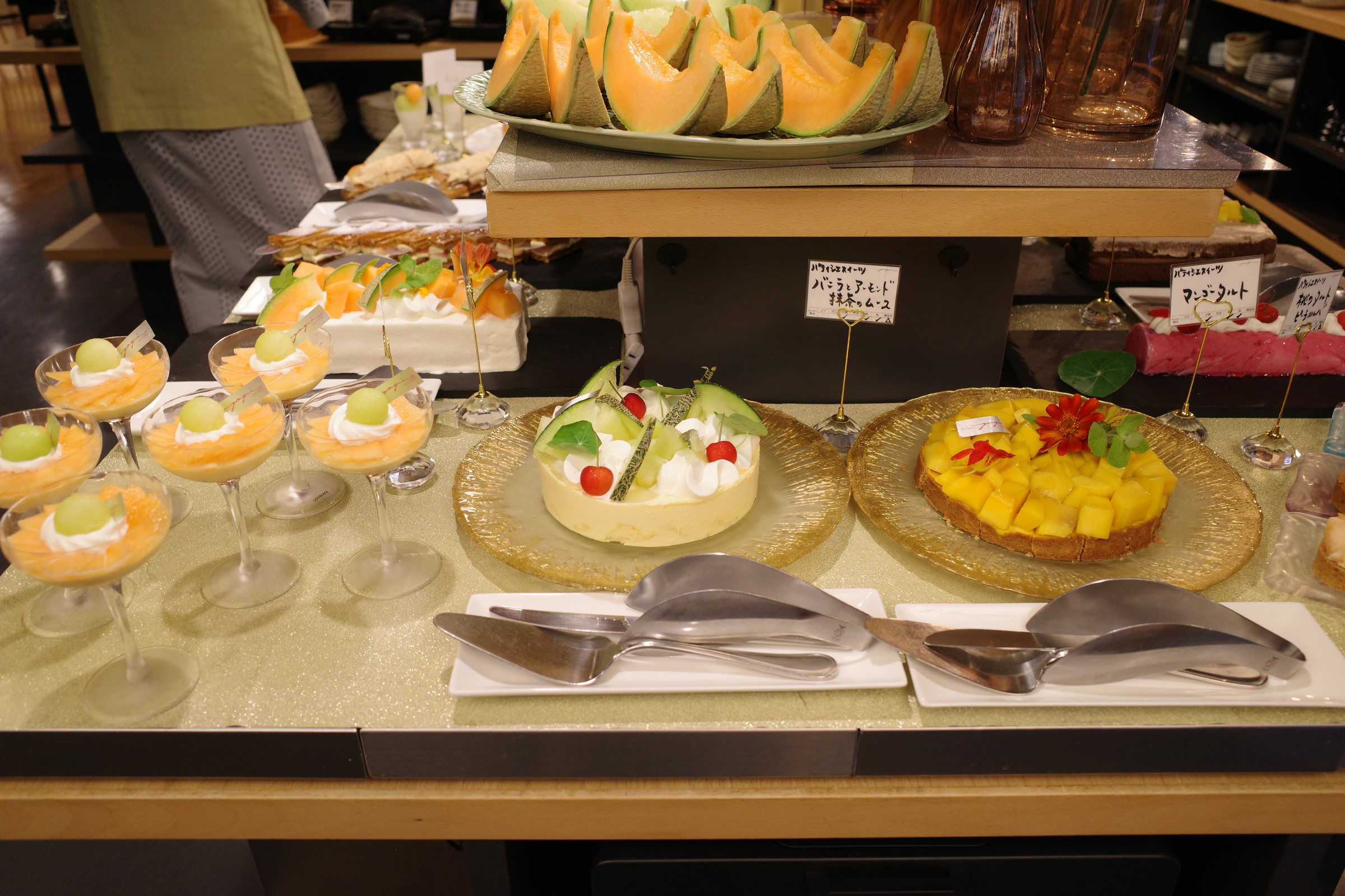 Fruit verrines and cakes on glass stands.