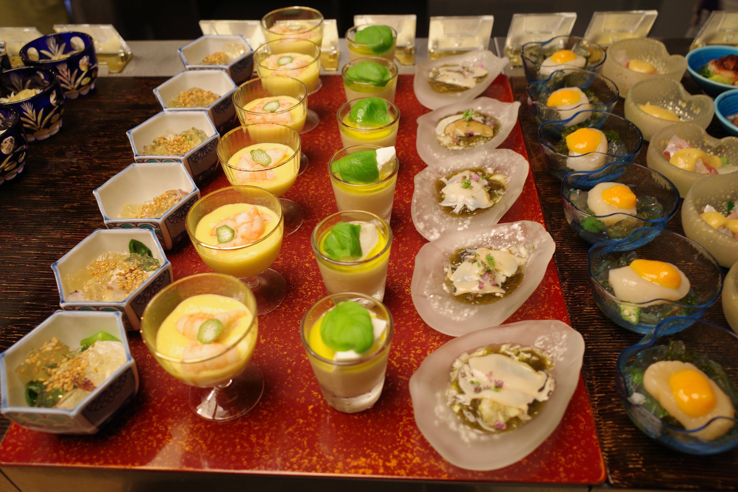 Mousses and dressed starters in little glasses and bowls.