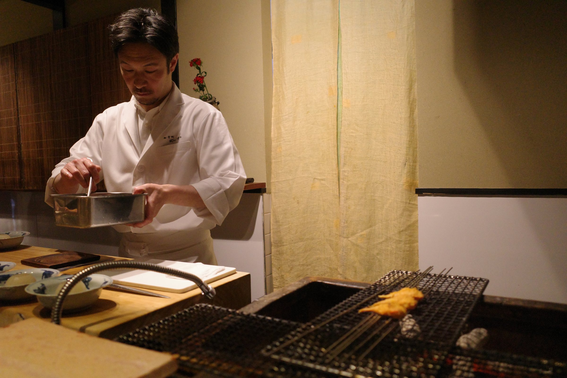 Working at the grill behind the counter.