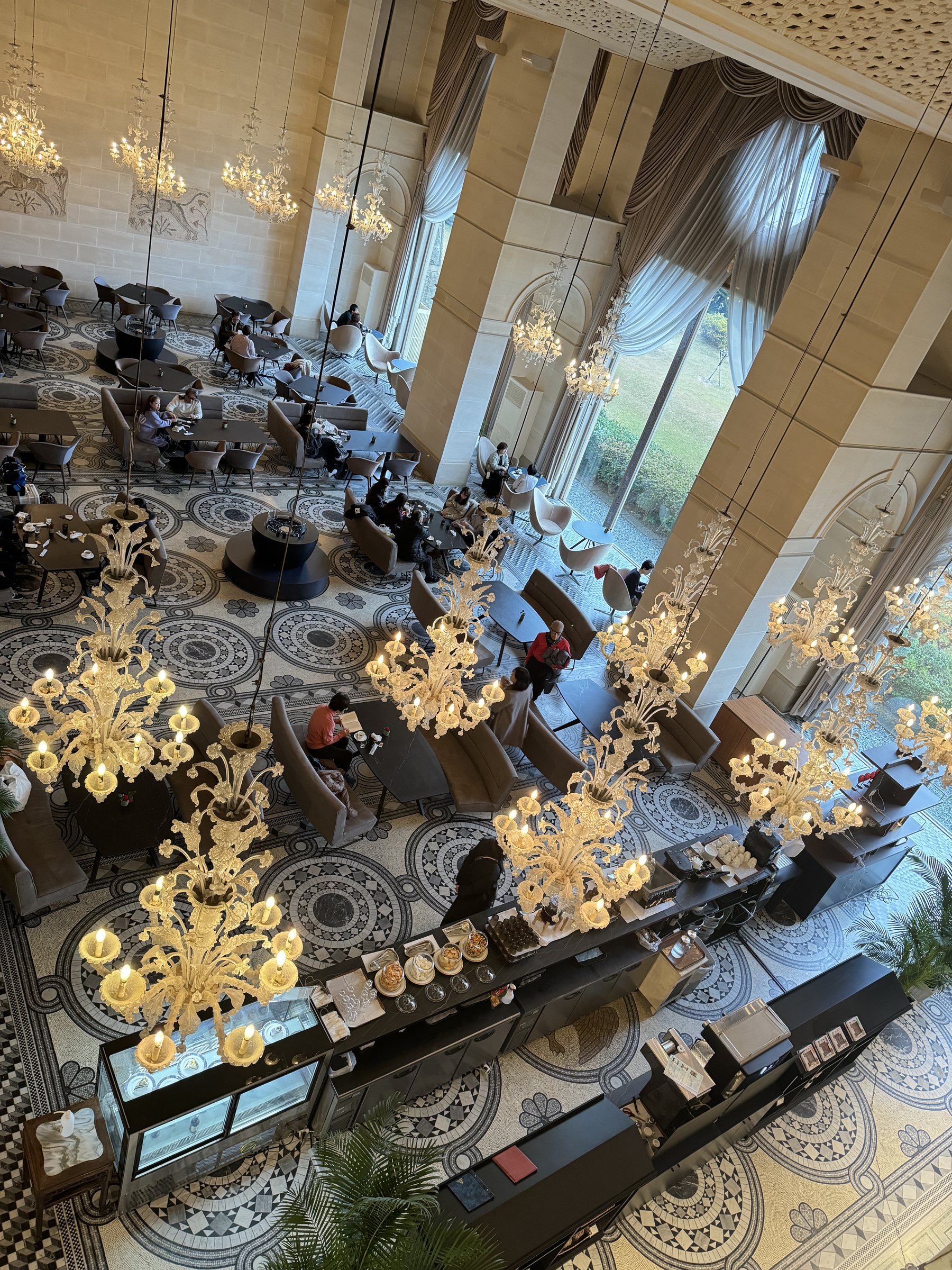 The salon from above, with glass chandeliers over the mosaic floor.