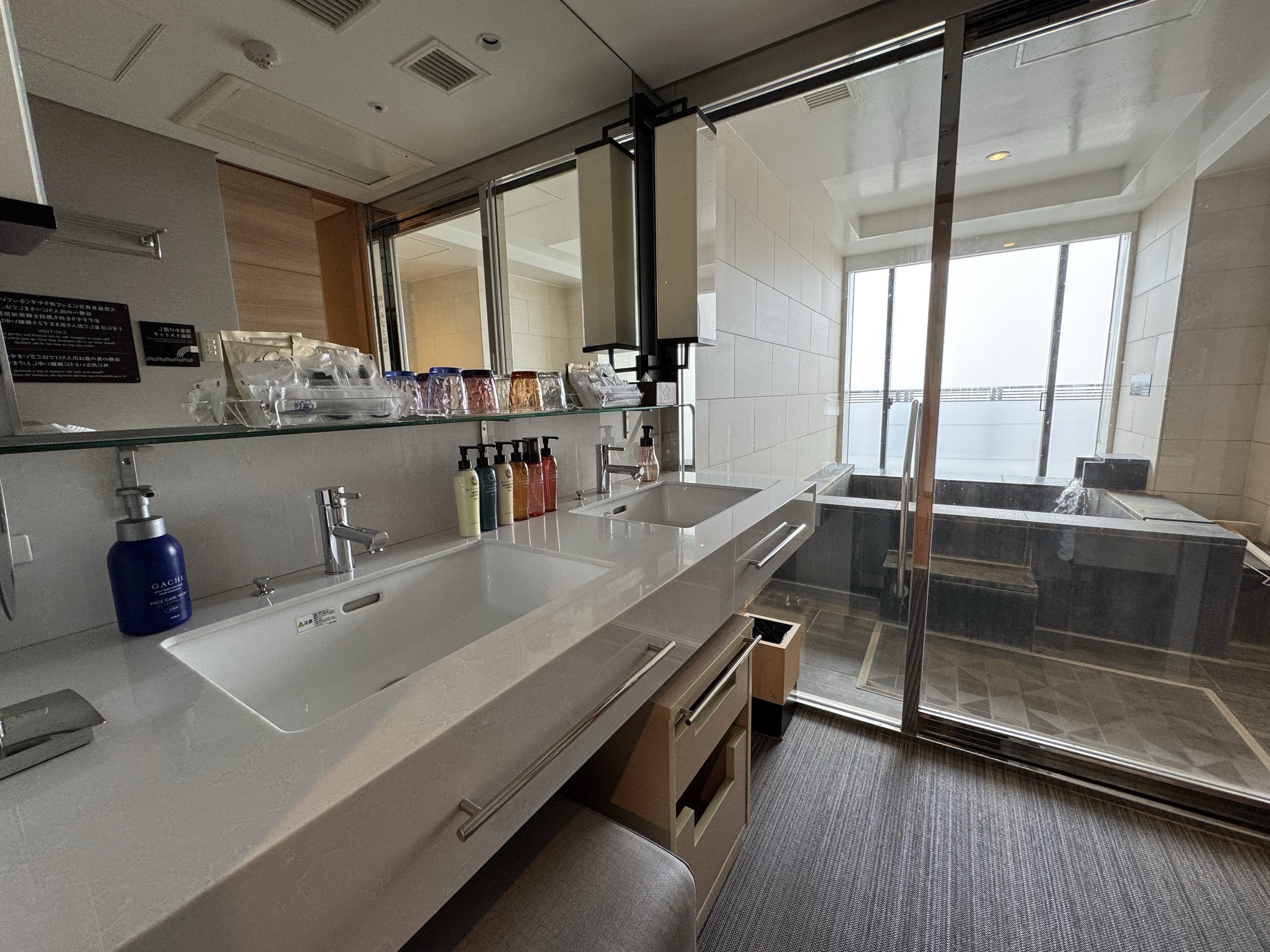 Twin washbasins and a row of toiletries.