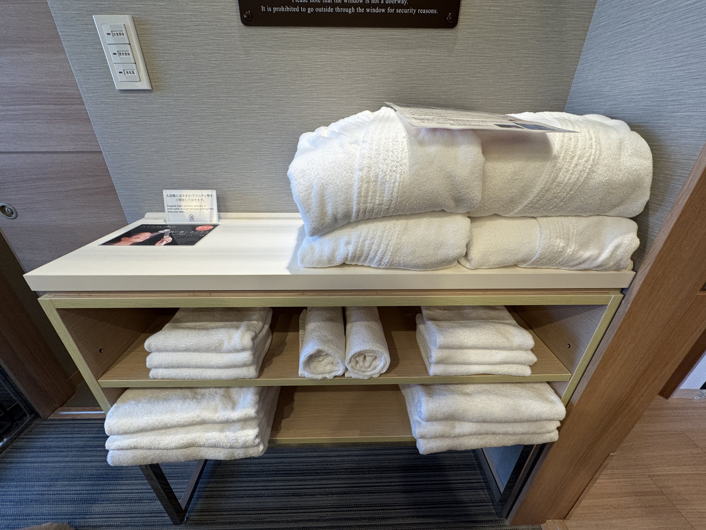 The changing area, with towels and bathrobes on open shelves.