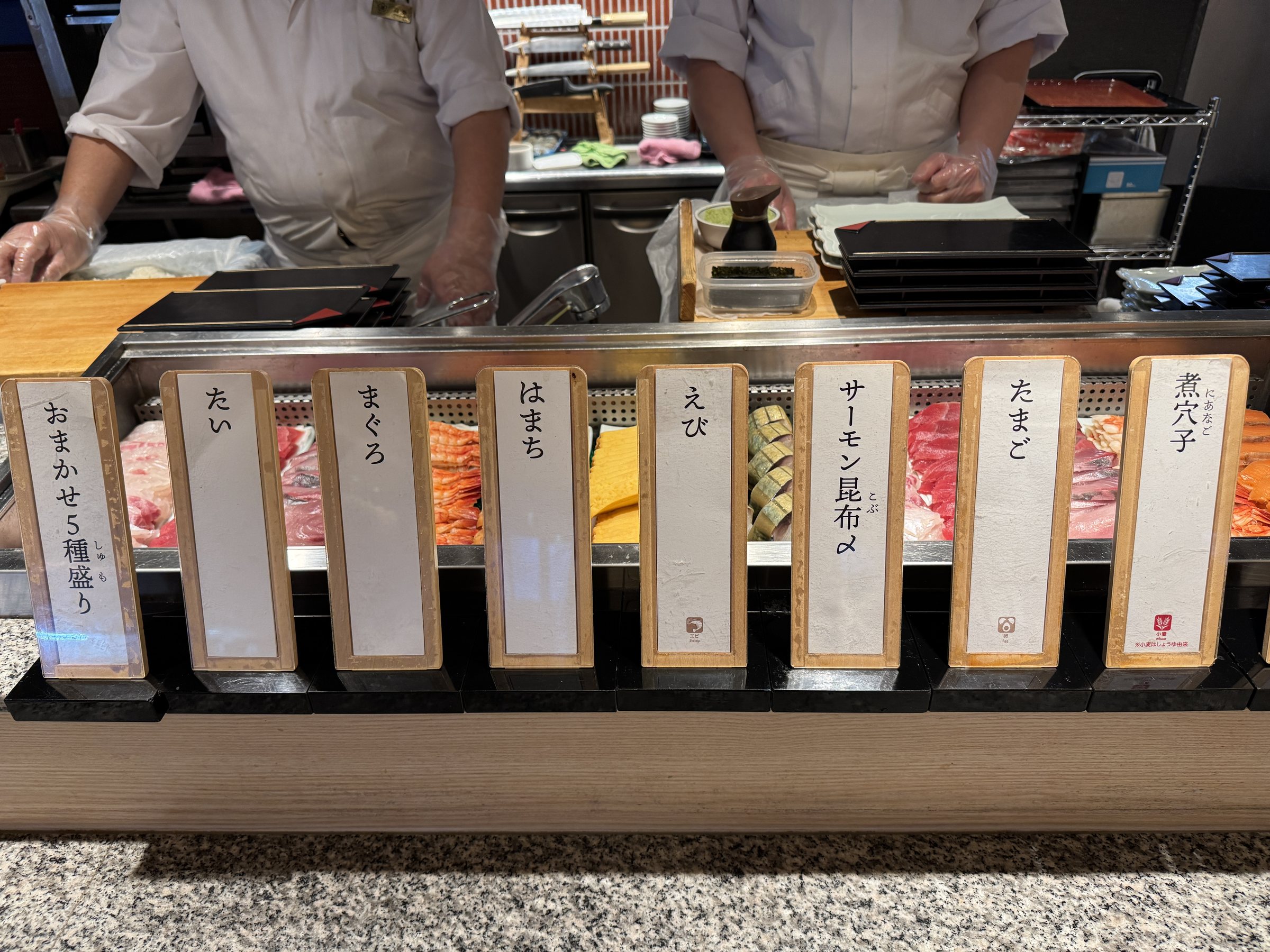 The sushi counter, with chefs at work.