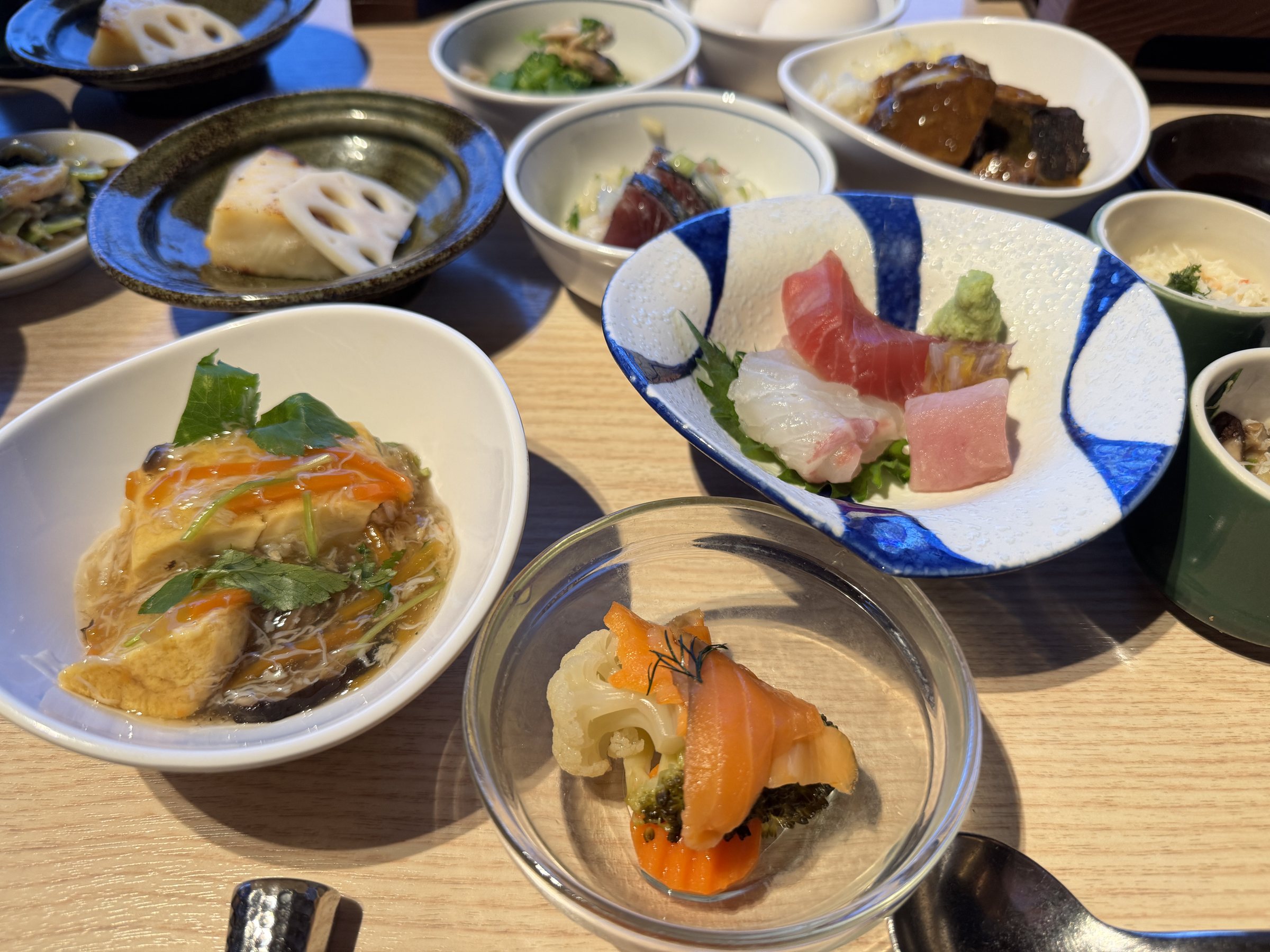 Sashimi, simmered dishes and small bowls from our table.