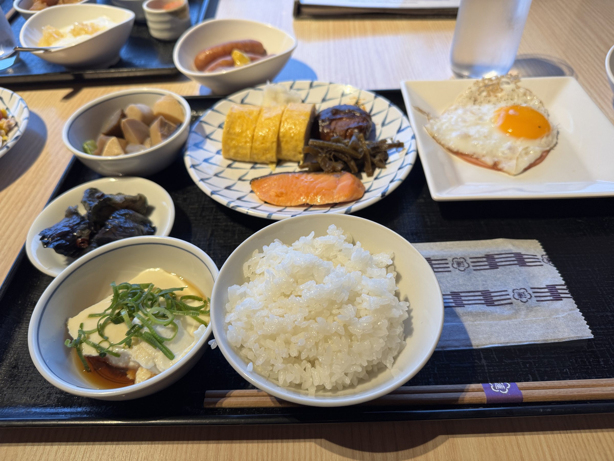 Our breakfast: rolled omelet, a fried egg, grilled fish and rice.