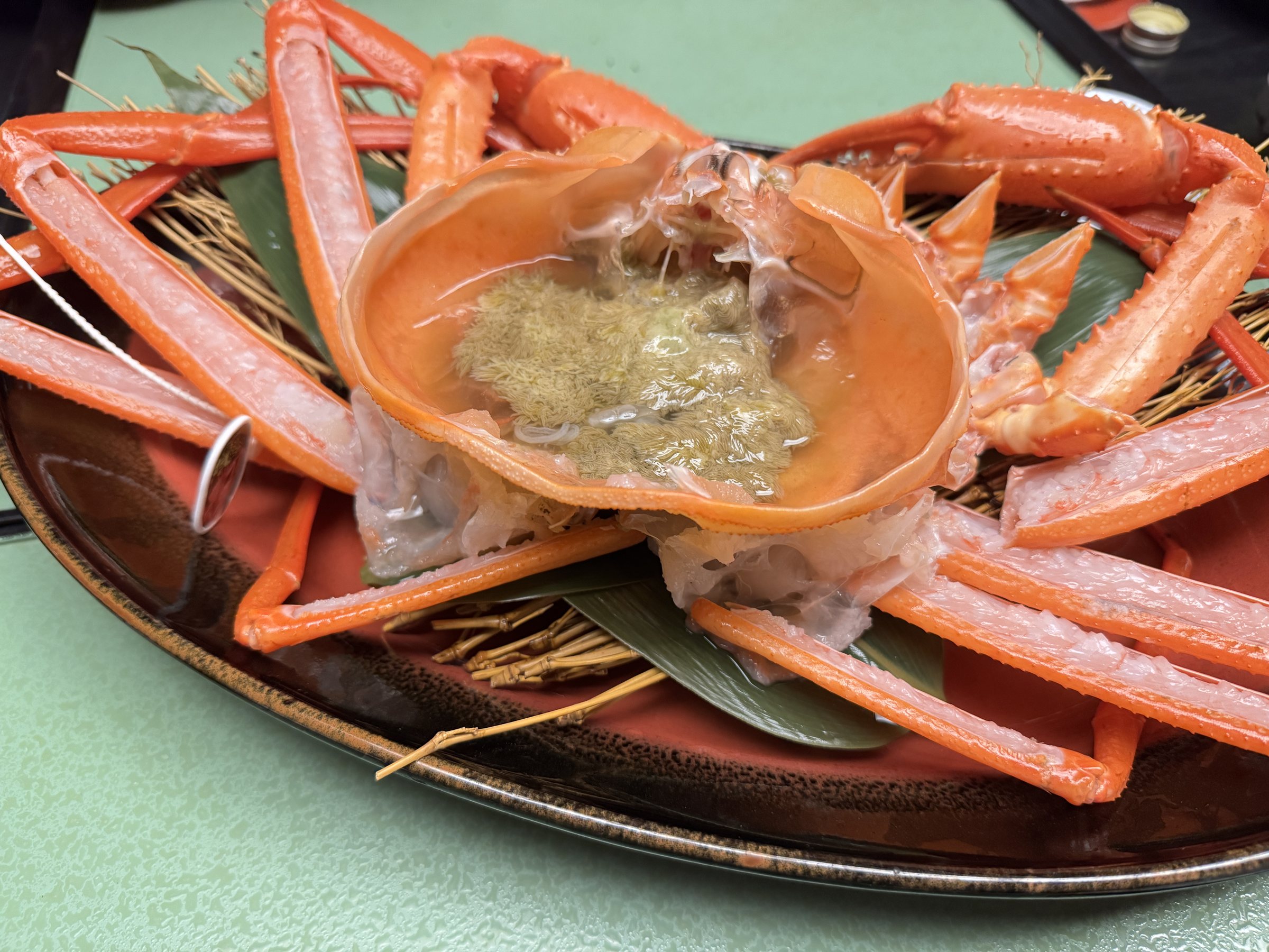 The red snow crab on its platter, shell filled with crab miso.