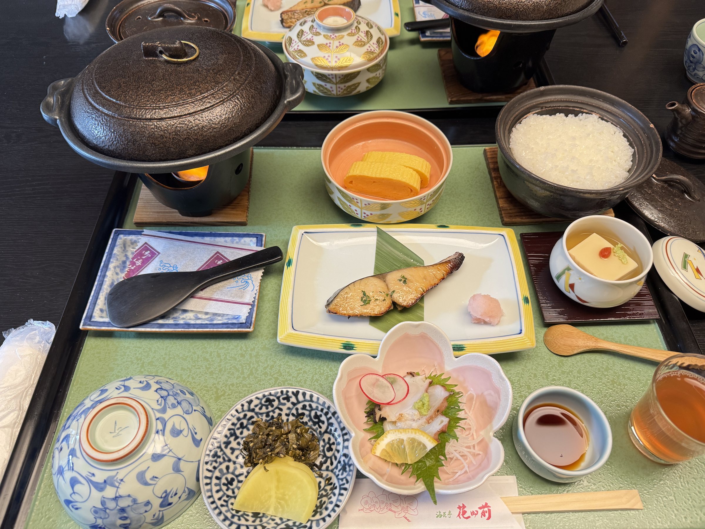 The breakfast tray: grilled fish, sashimi, rice and a pot of warm vegetables.