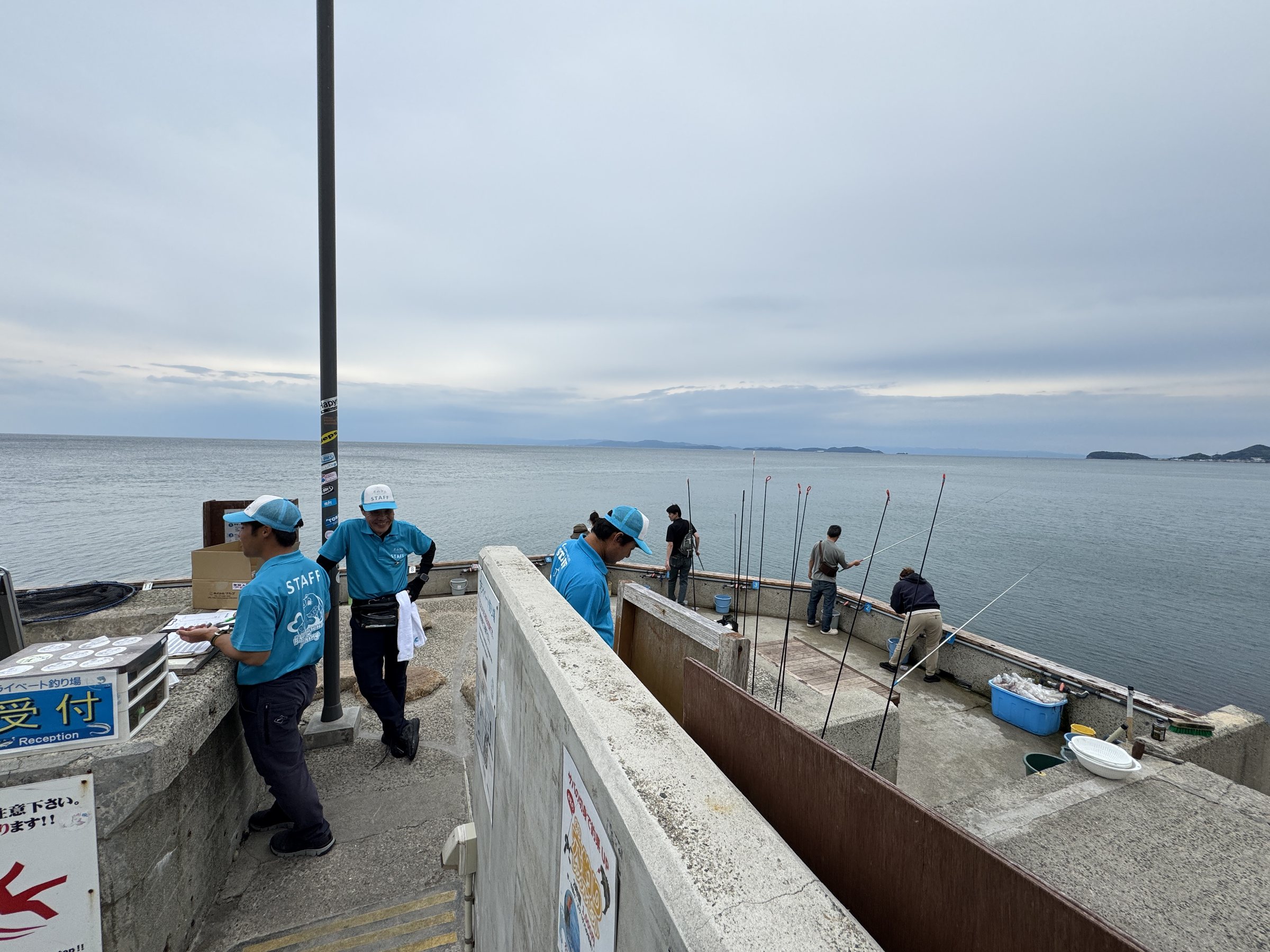 Anglers lined up along the sea wall.