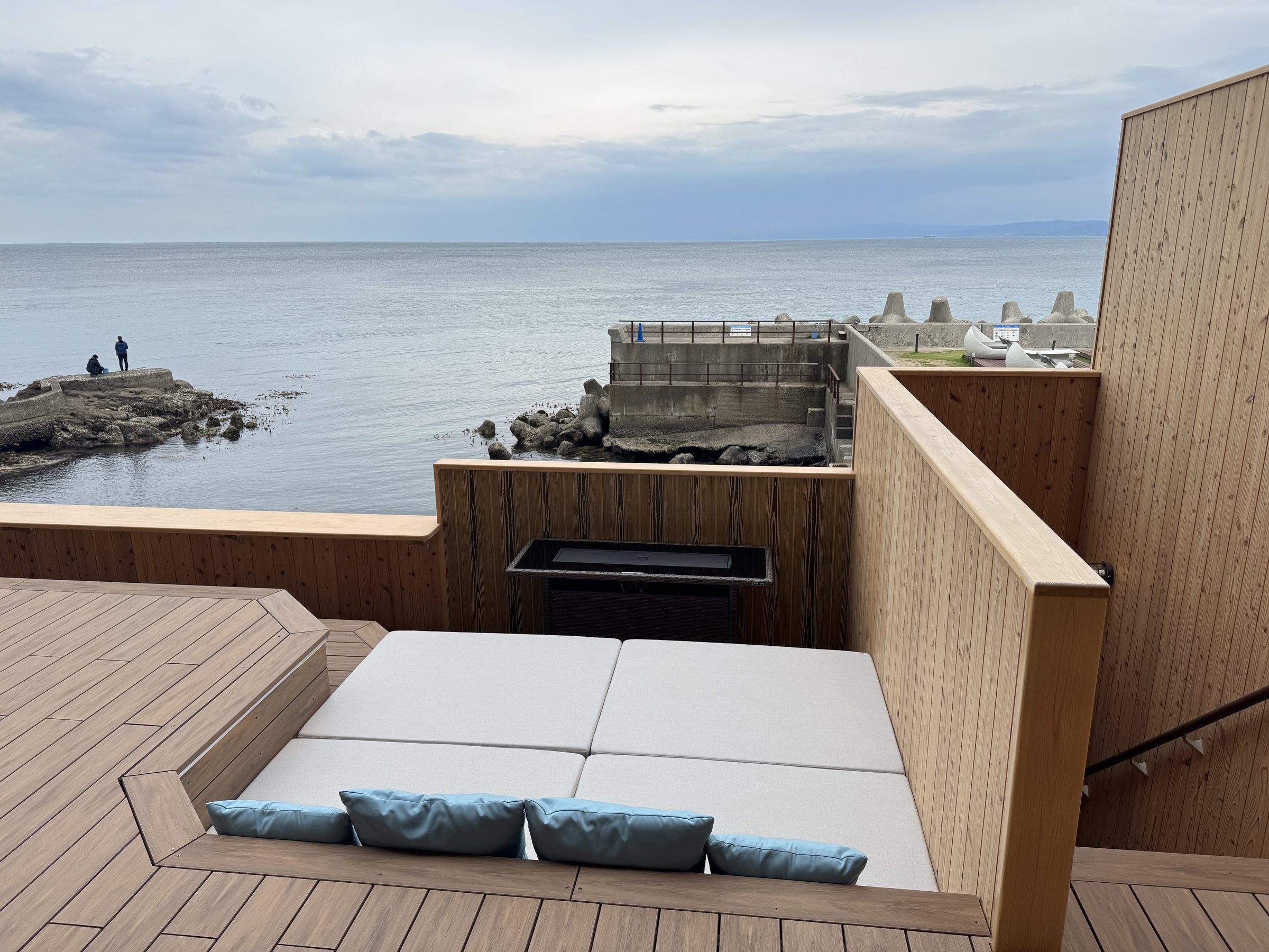The balcony, with a daybed and the sea beyond.