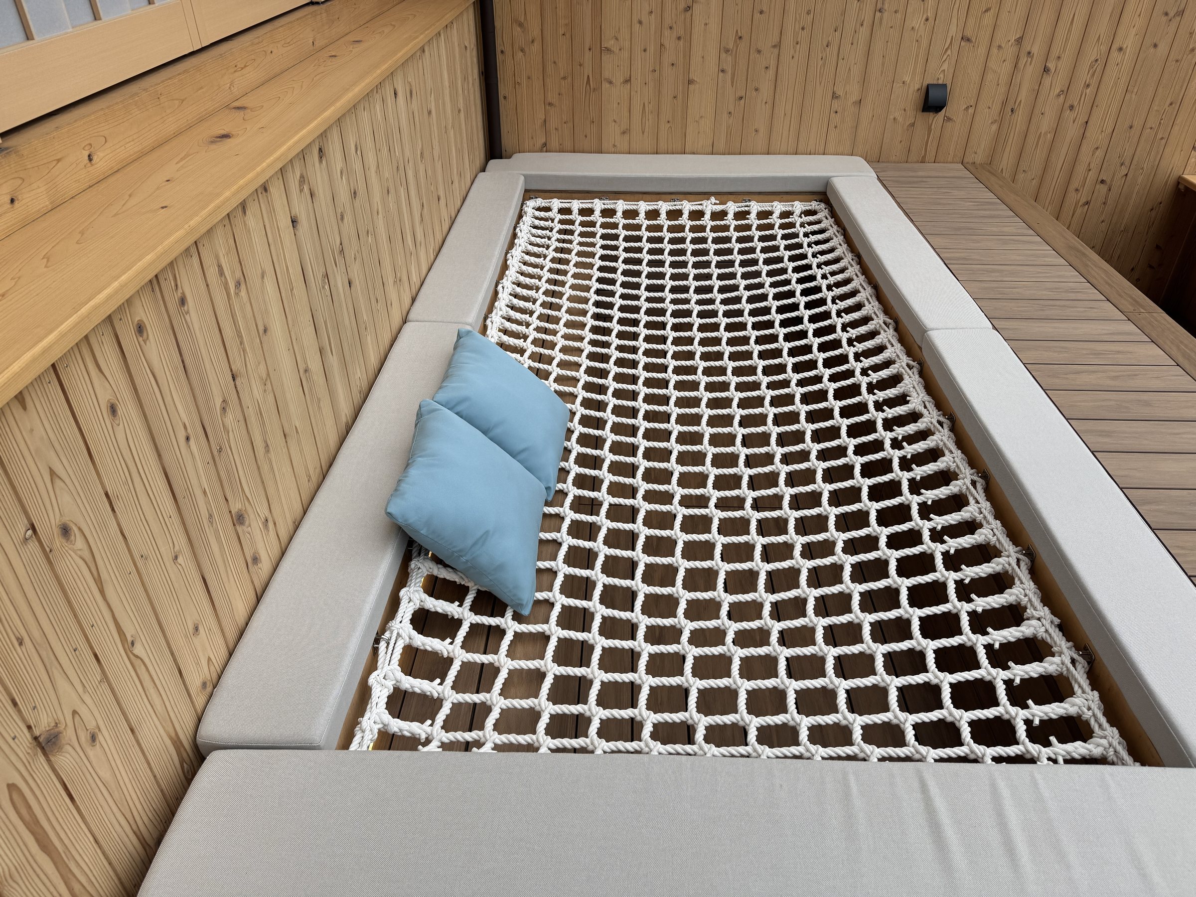 A rope hammock built into the balcony.
