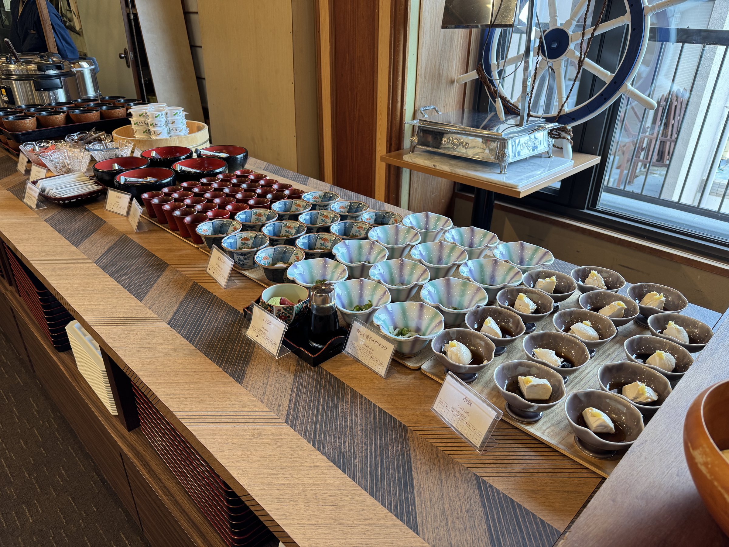 Rows of small dishes and lacquered bowls.