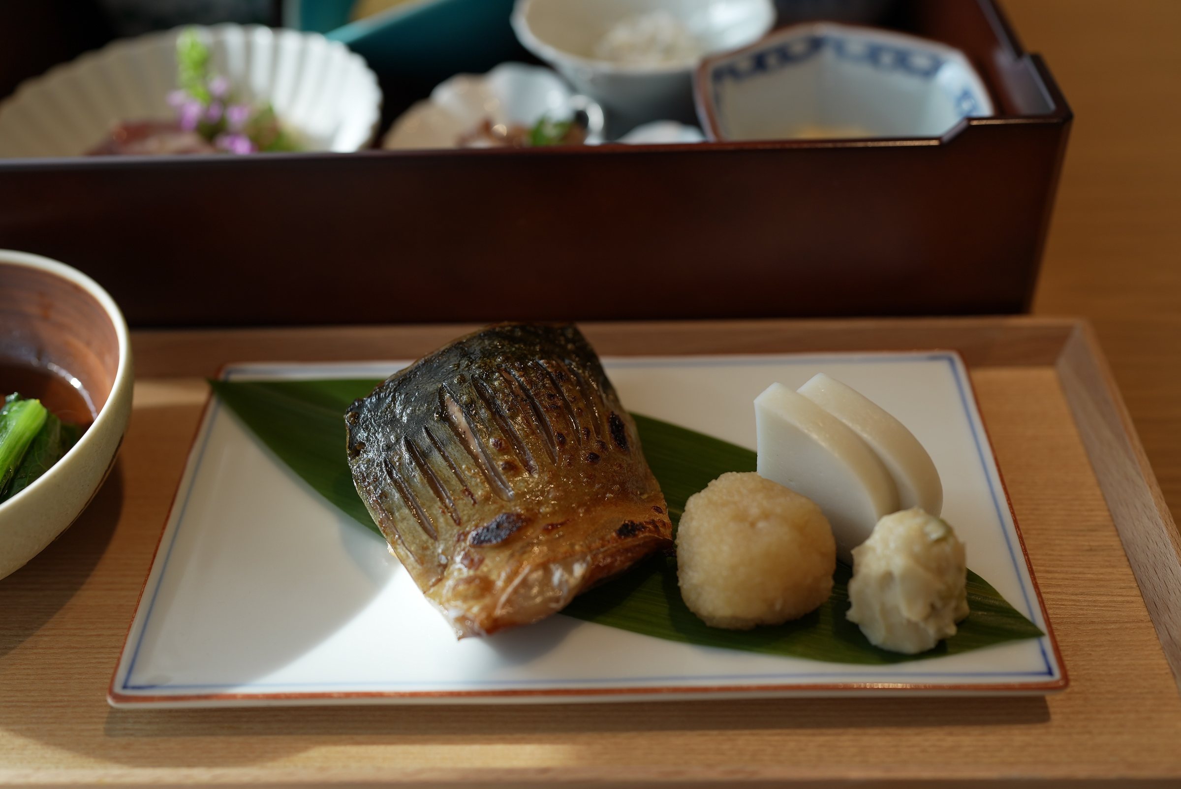 Grilled dried mackerel with kamaboko and a mound of grated daikon.