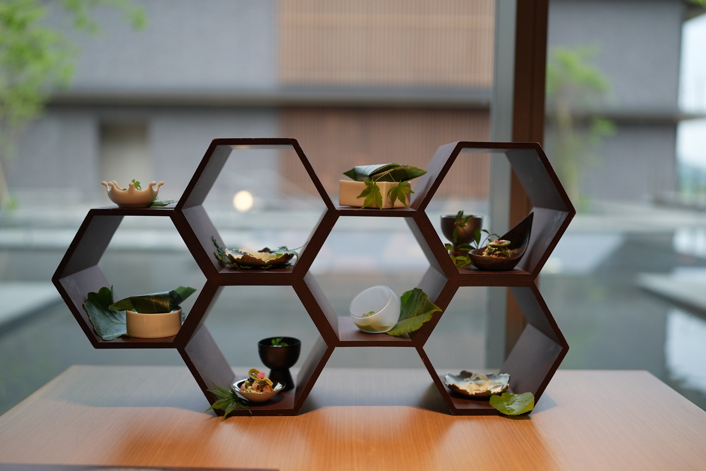 The appetisers, set into a hexagonal timber frame before the water garden.