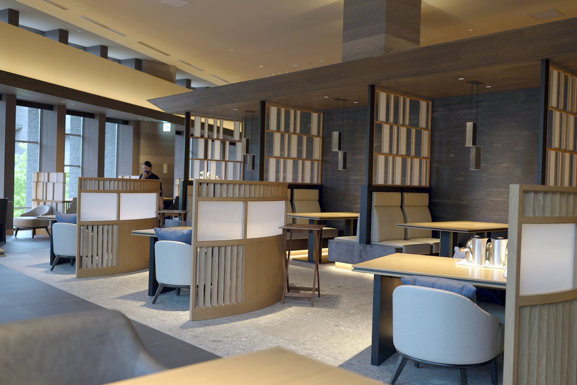 The dining room: dark timber, screens and soft light.