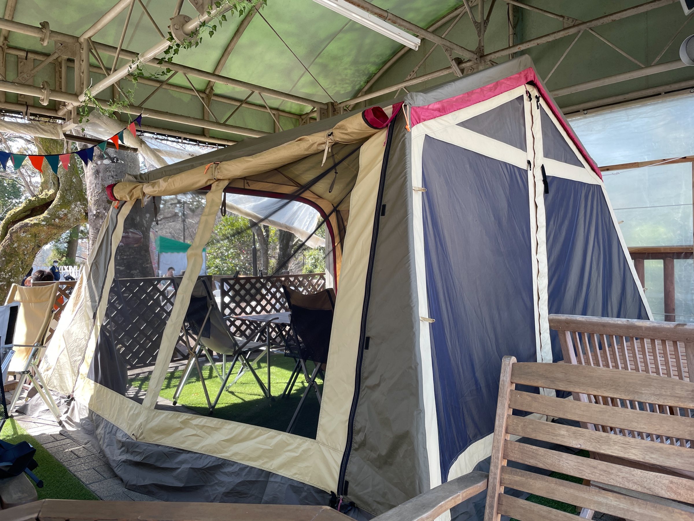 One of the canvas tents, set up beneath bunting.