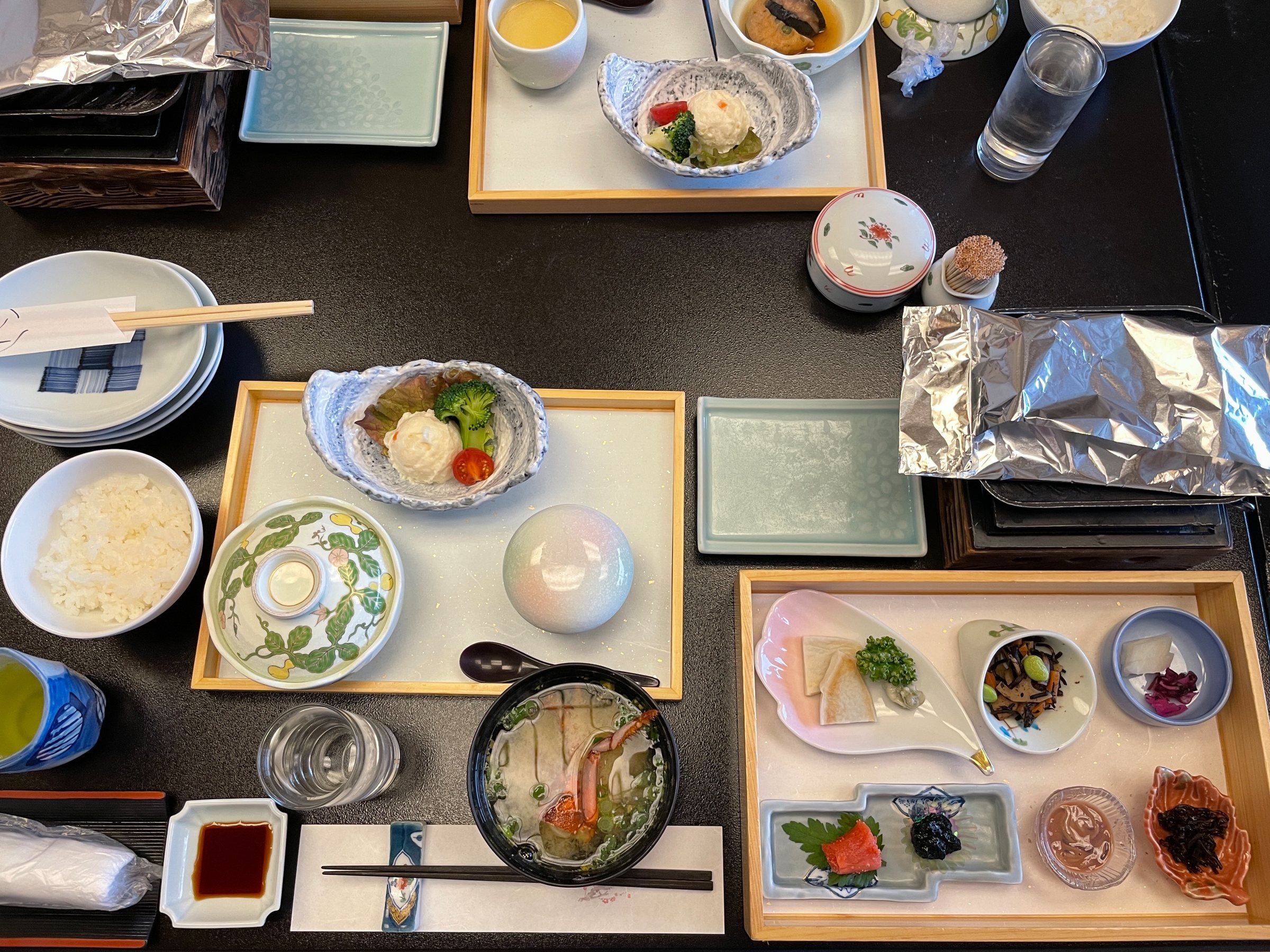 The Japanese breakfast spread: an array of small dishes, soup and condiments.