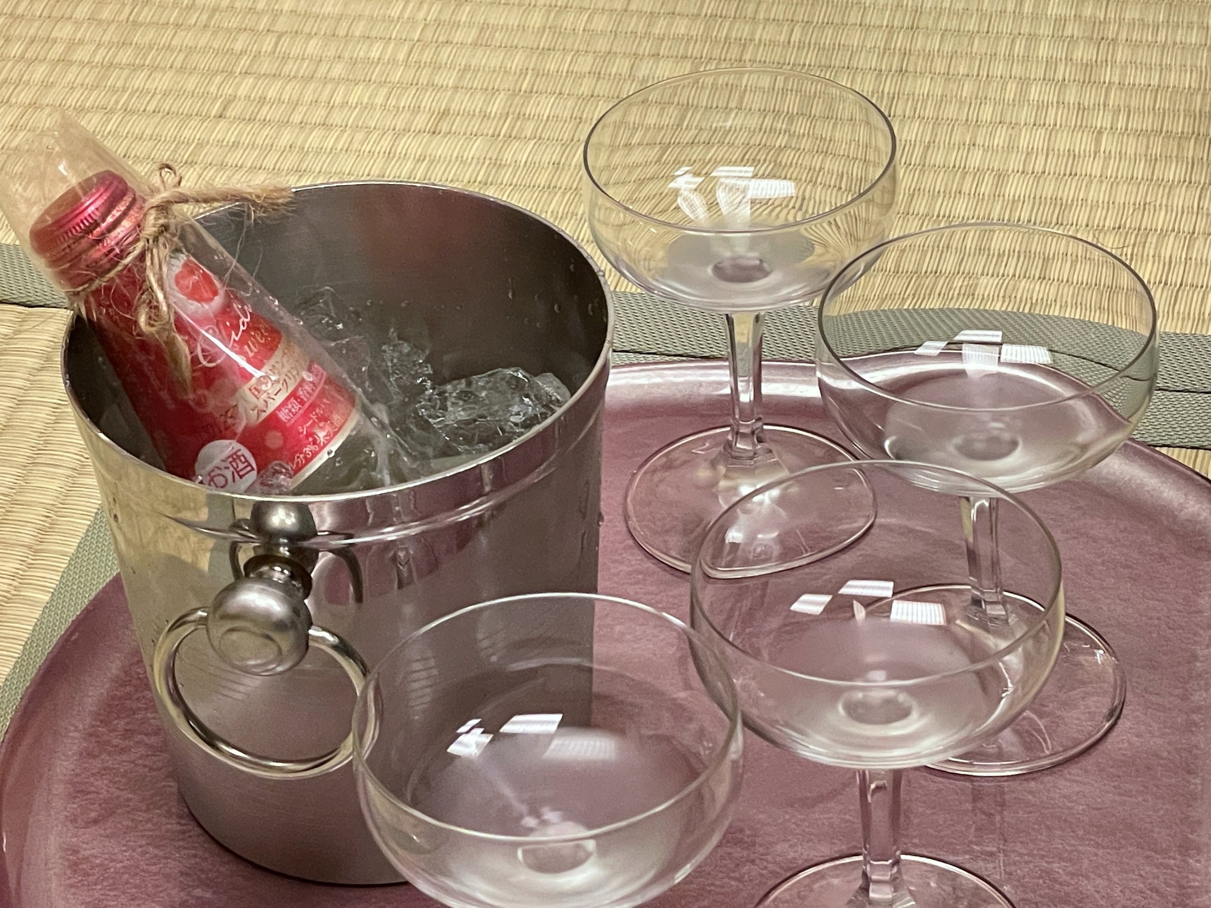 The celebration bottle on ice, with four coupes.