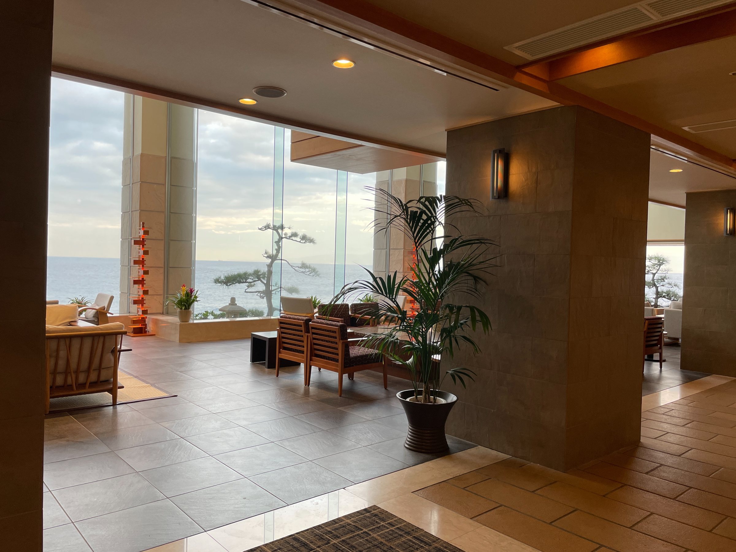 The lobby, glazed floor to ceiling onto sea and sky.
