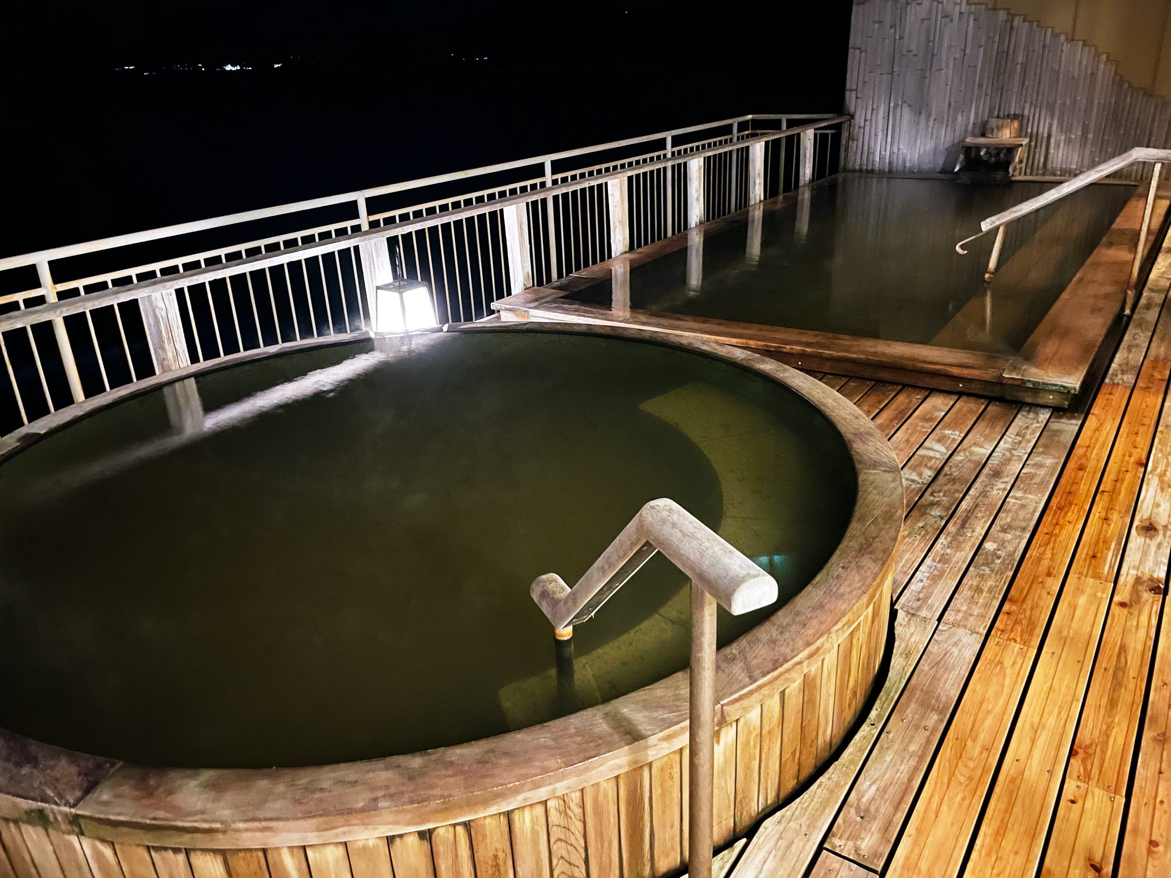 The rooftop tub and its wooden deck at night.
