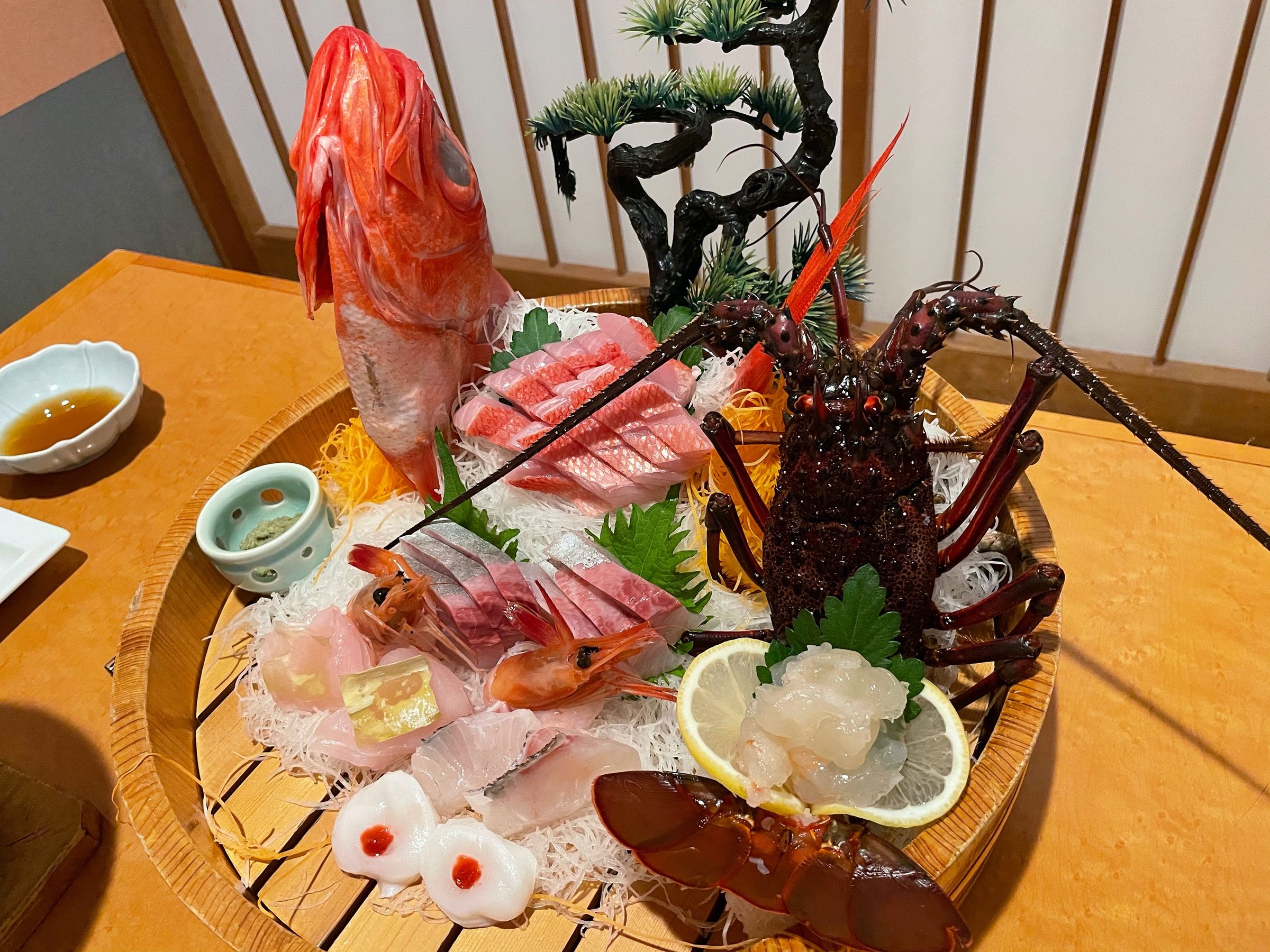 The sashimi boat: kinmedai, tuna and a whole spiny lobster.