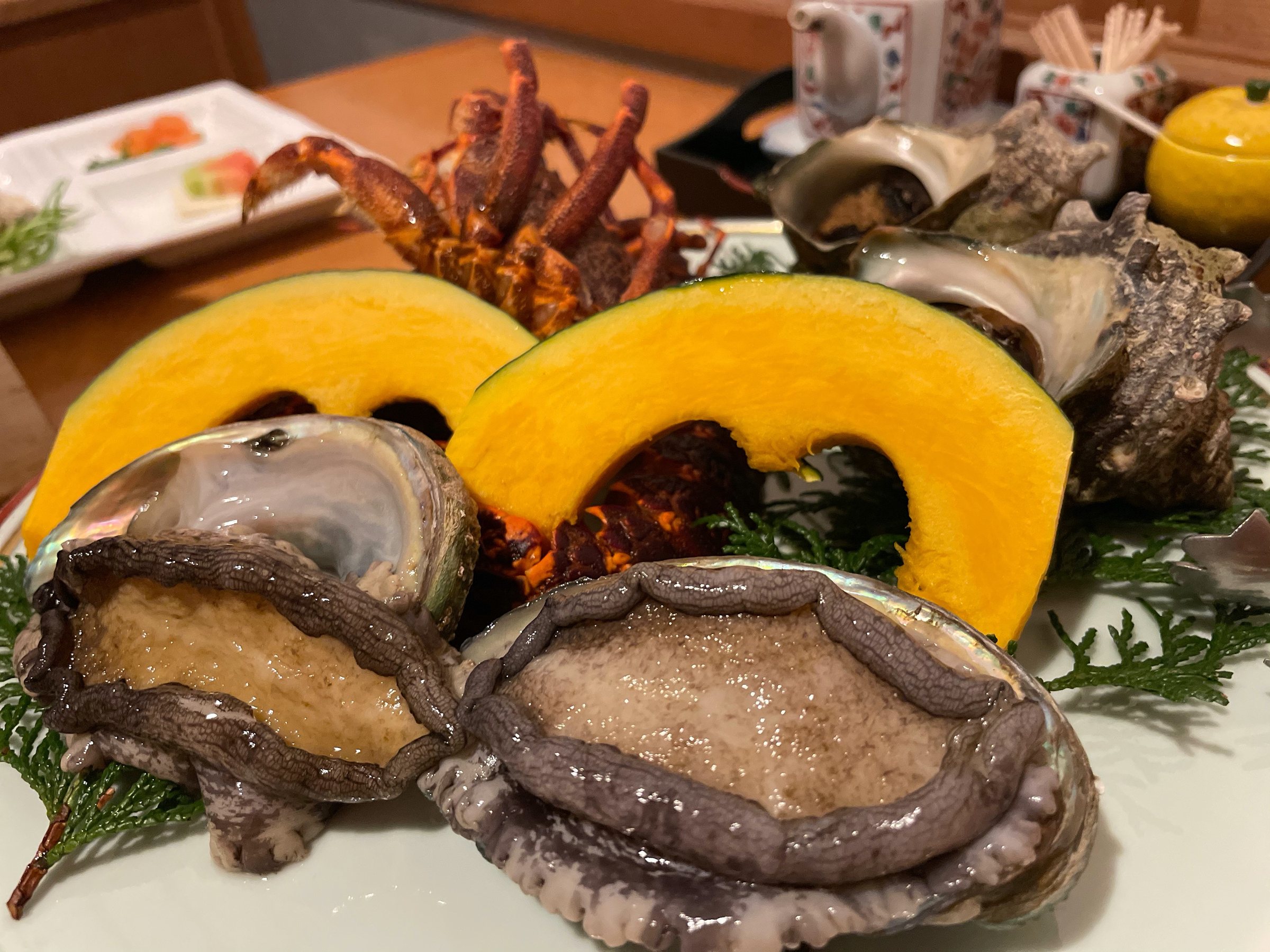 Abalone, turban shells and spiny lobster, with wedges of kabocha for the grill.