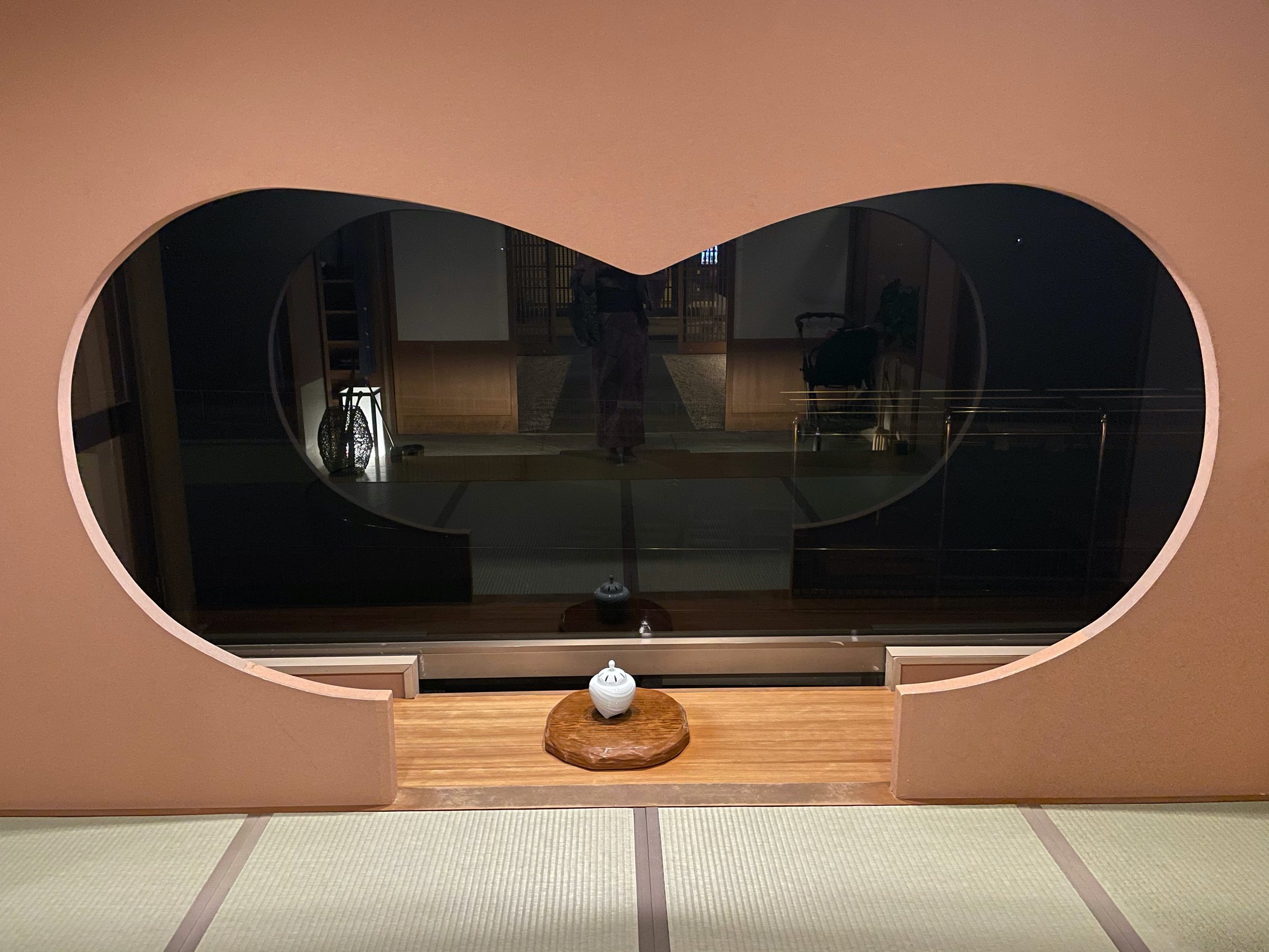 A rounded window framing the lounge in soft light.