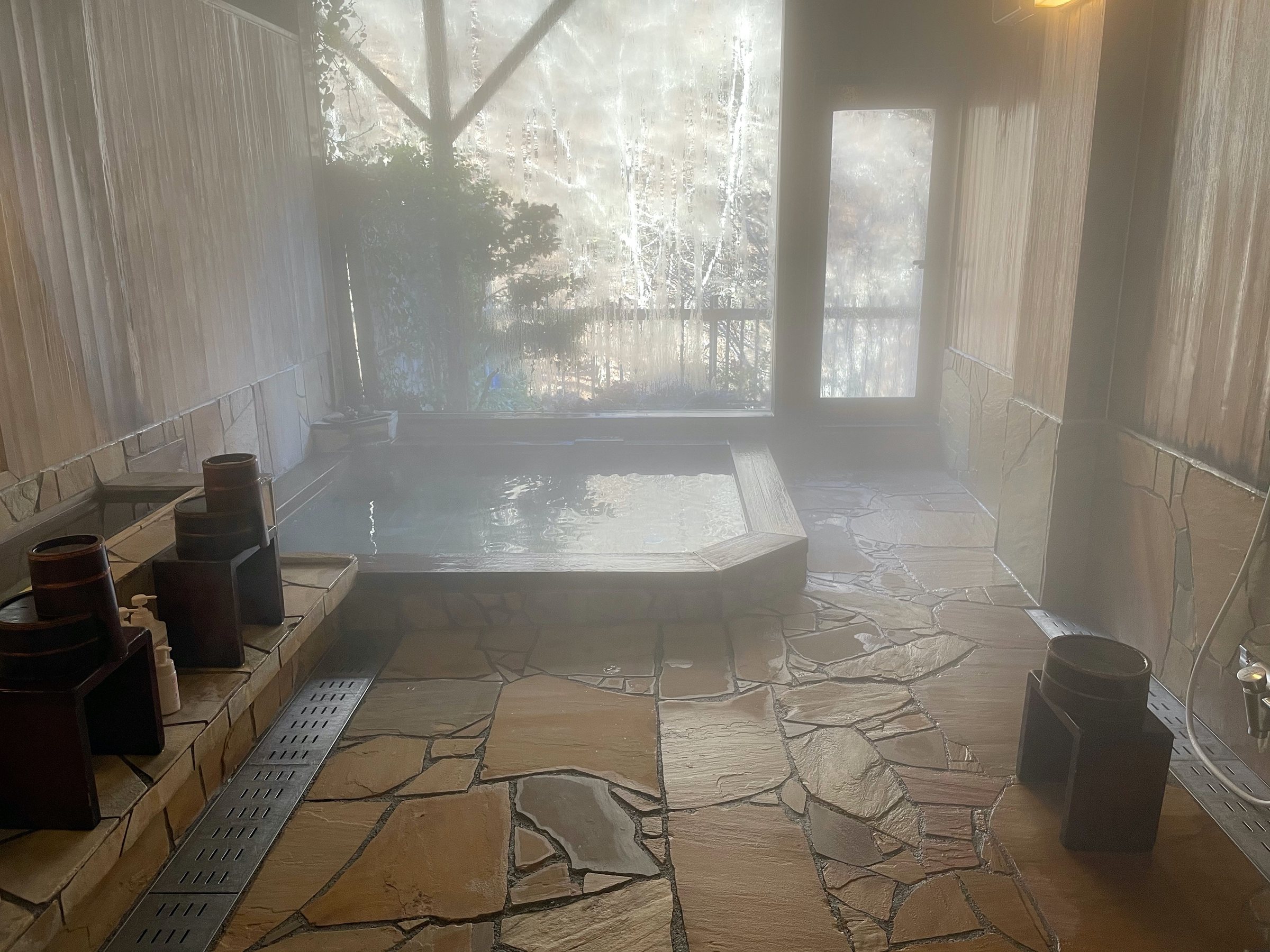 The indoor bath, wreathed in steam.