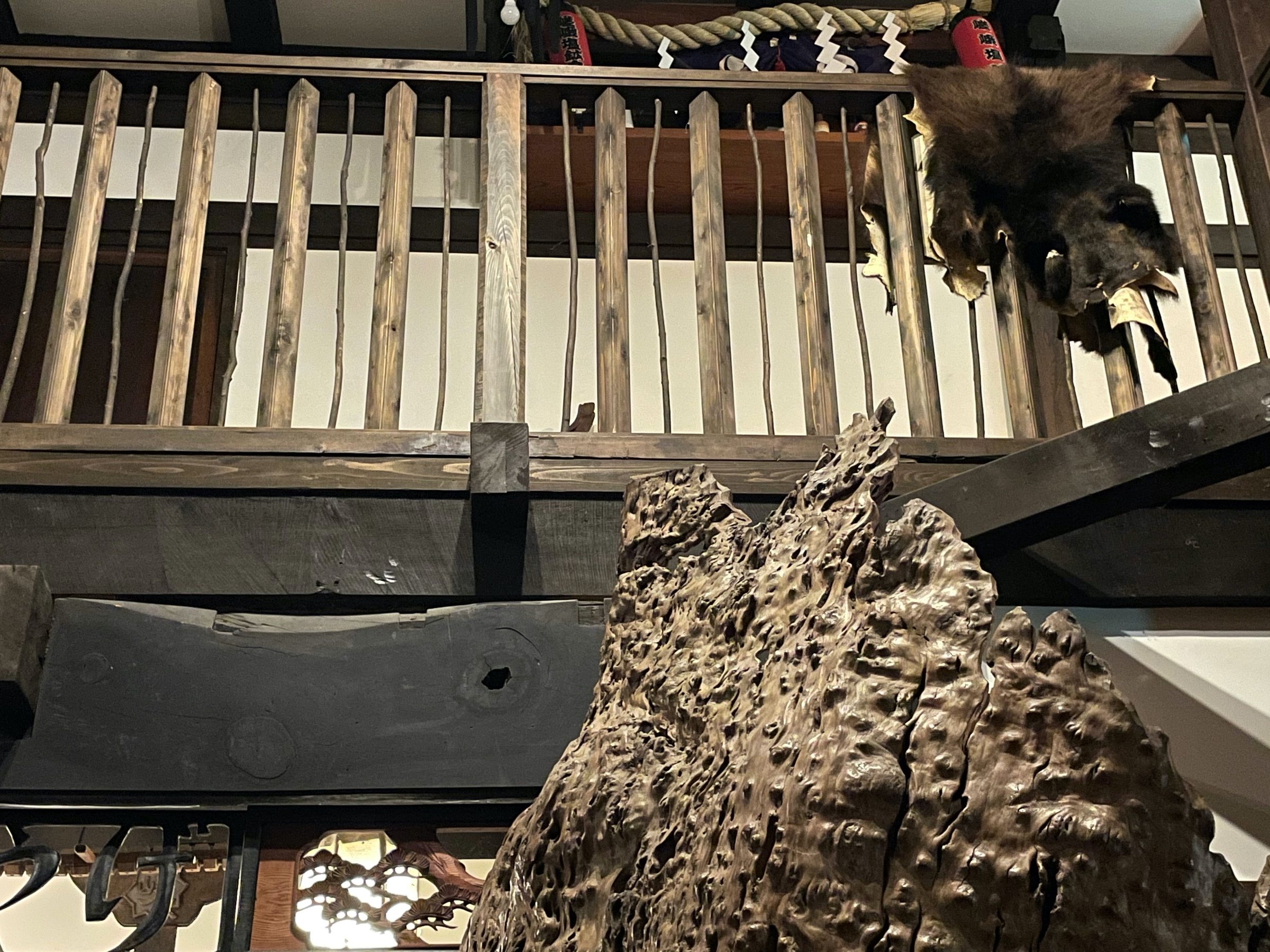 A fur over the balustrade and sculptural wood below.