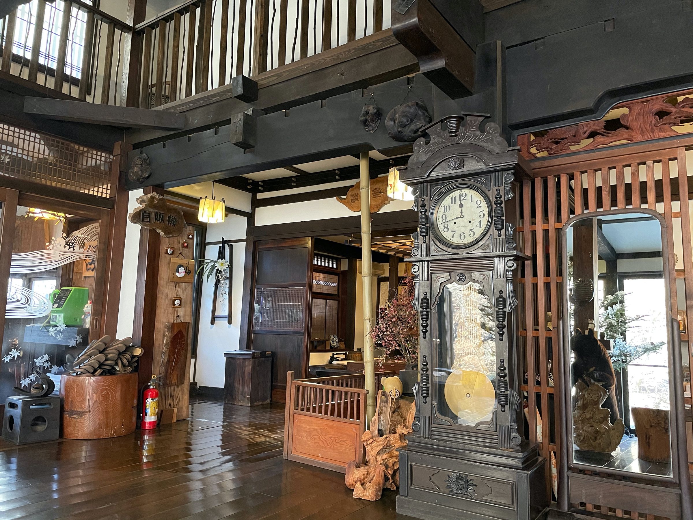 The lobby: a tall clock, dark timbers and curiosities on every surface.