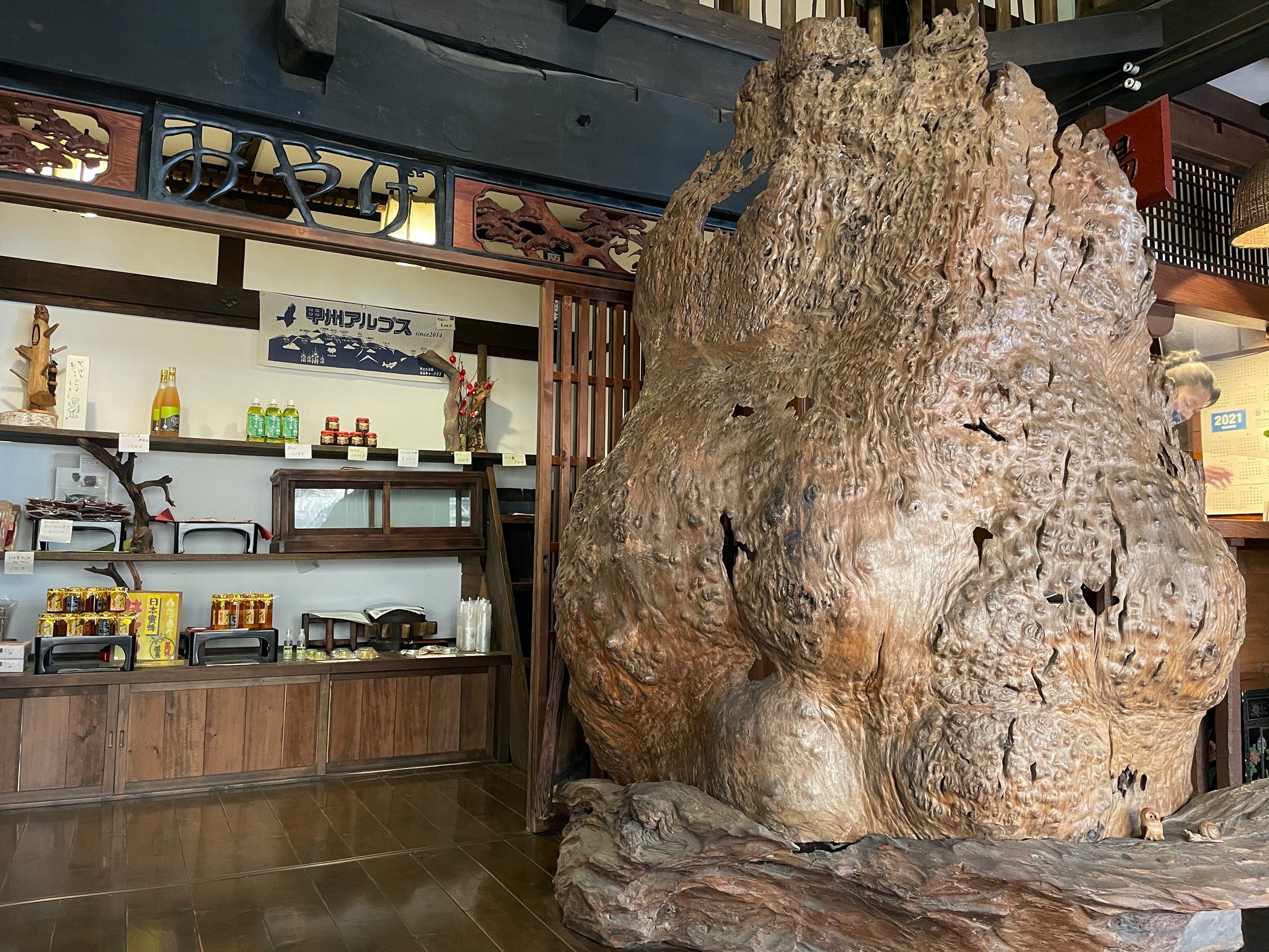 A great carved burl dominates the lobby beside the shop shelves.