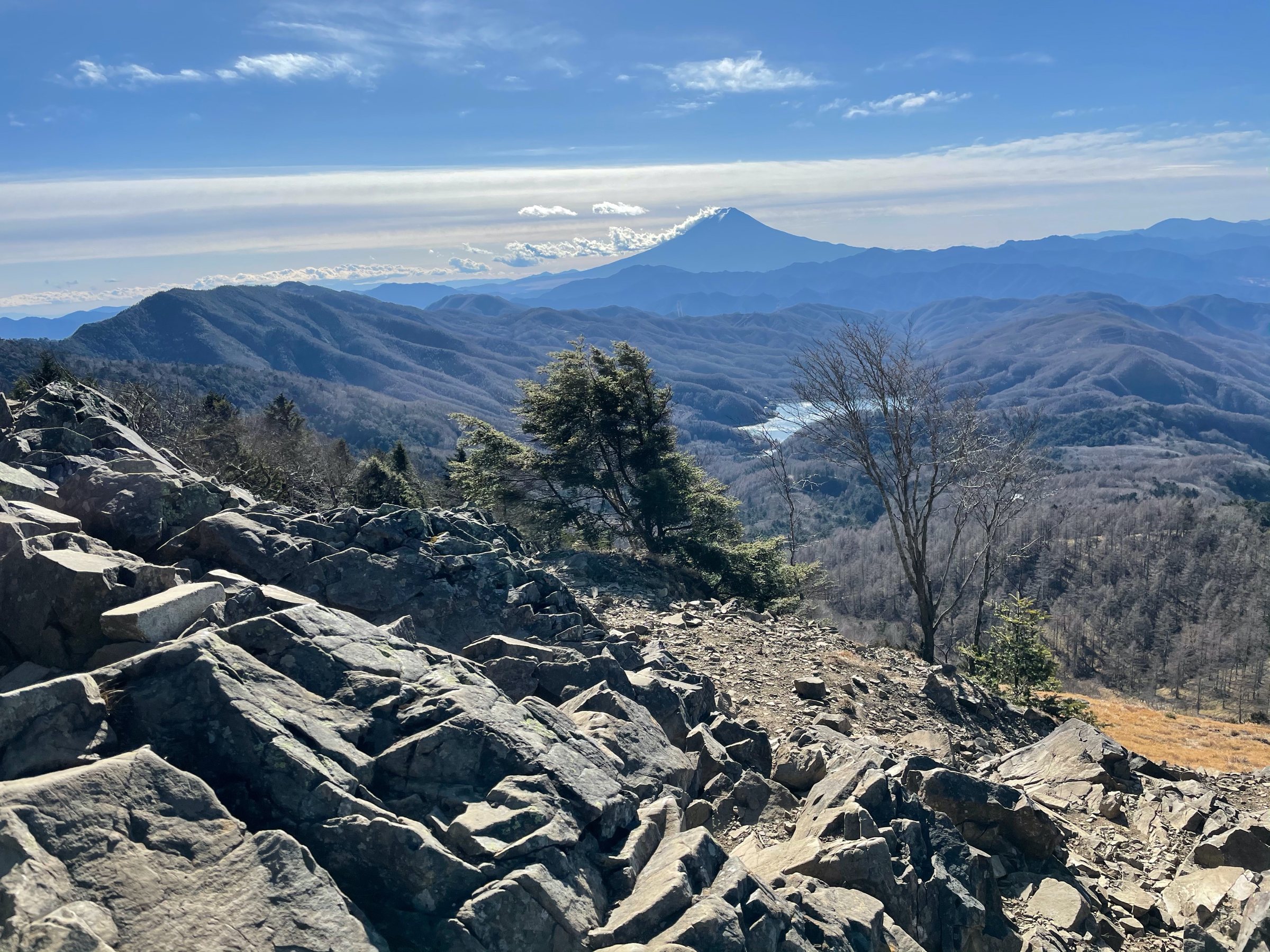 The rocky summit area, with Fuji floating above the haze.