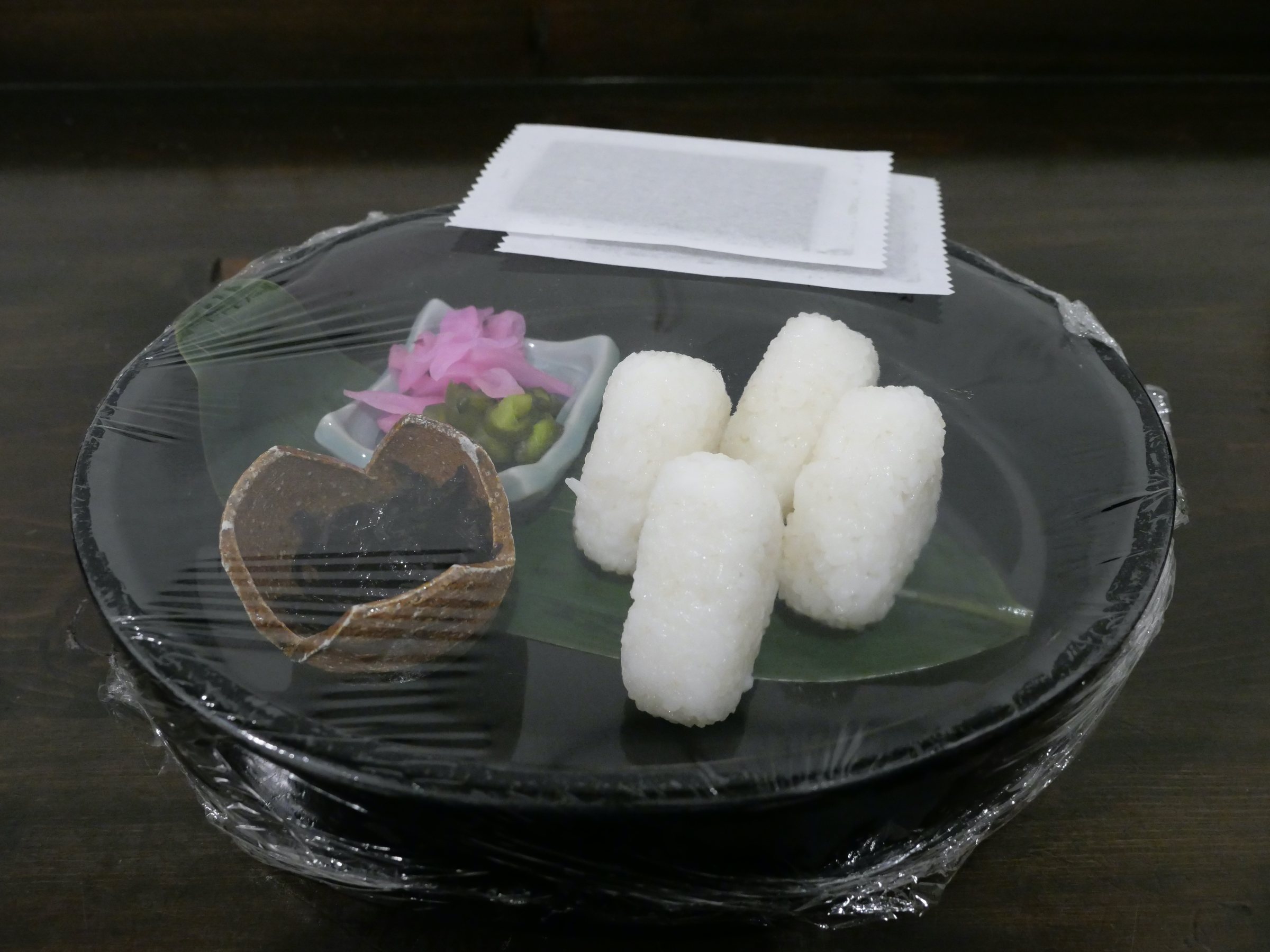 Late-night rice balls, with pickles, delivered to the villa.