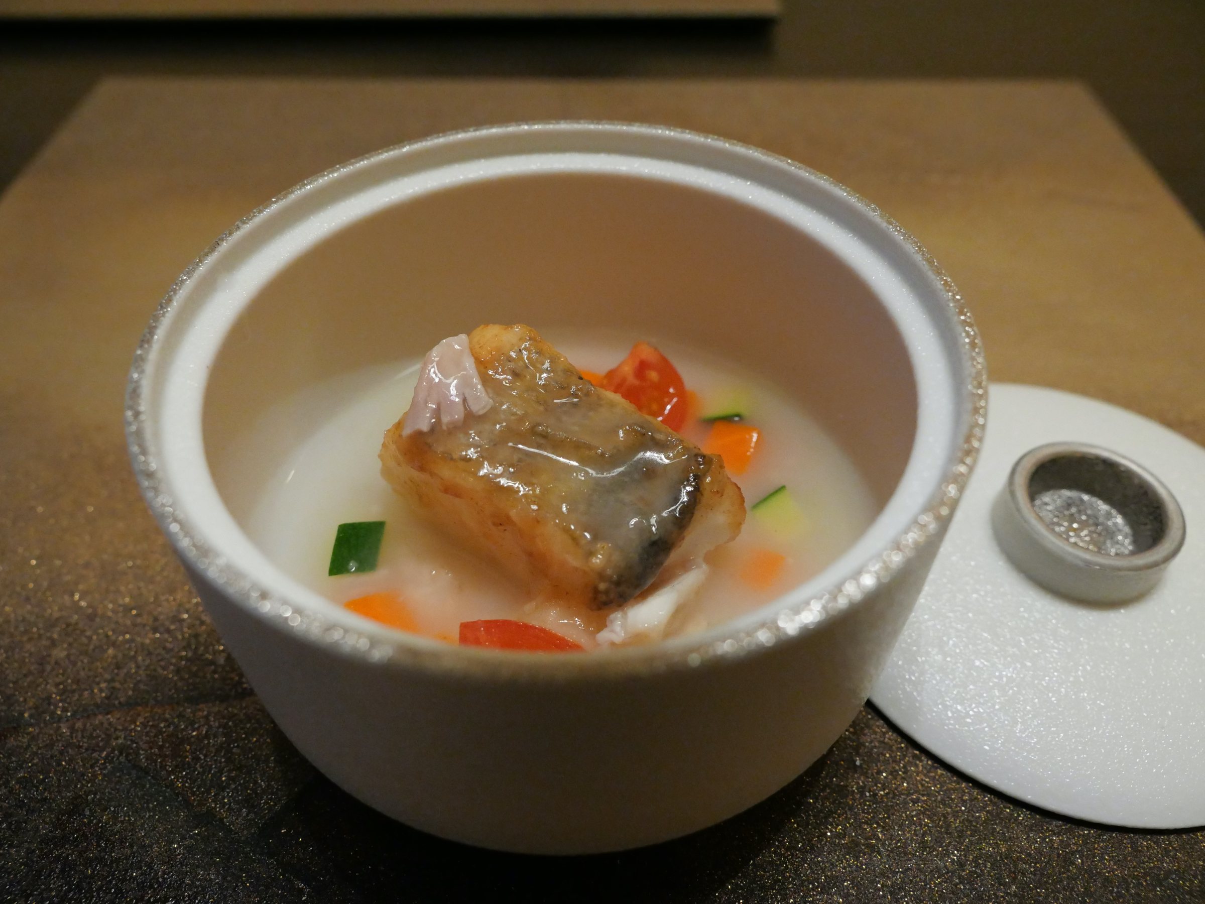 Fish in a delicate cream sauce, with diced vegetables.