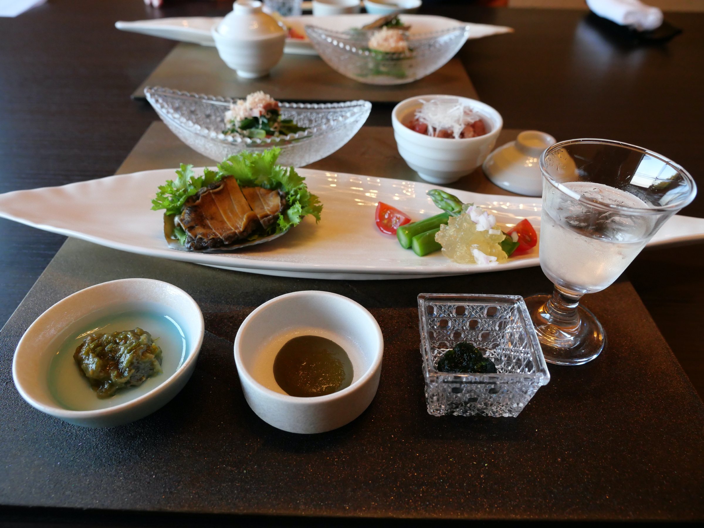 The opening course, the abalone at its center, surrounded by small dishes.