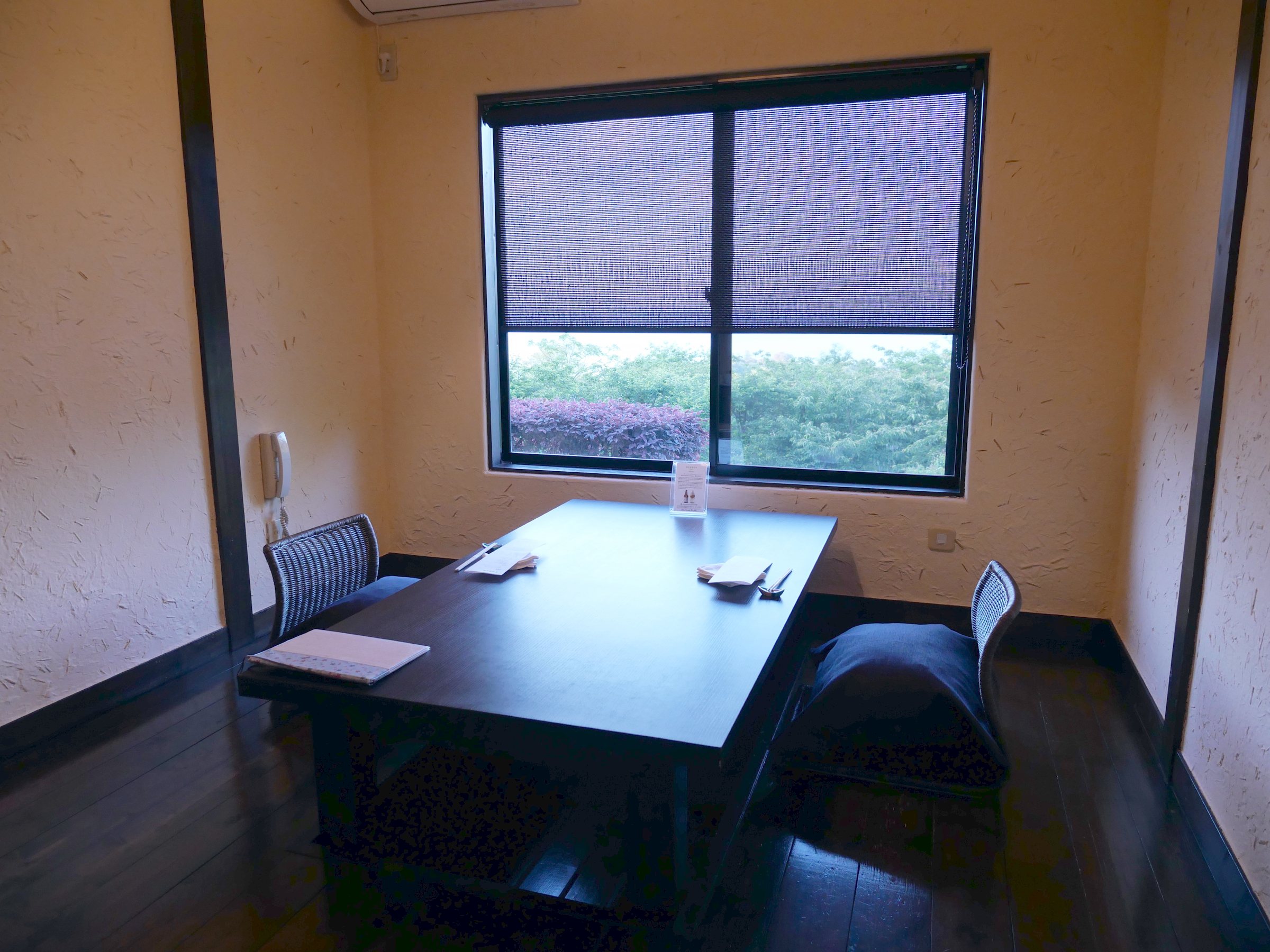 A writing desk by the window, the garden in bloom outside.