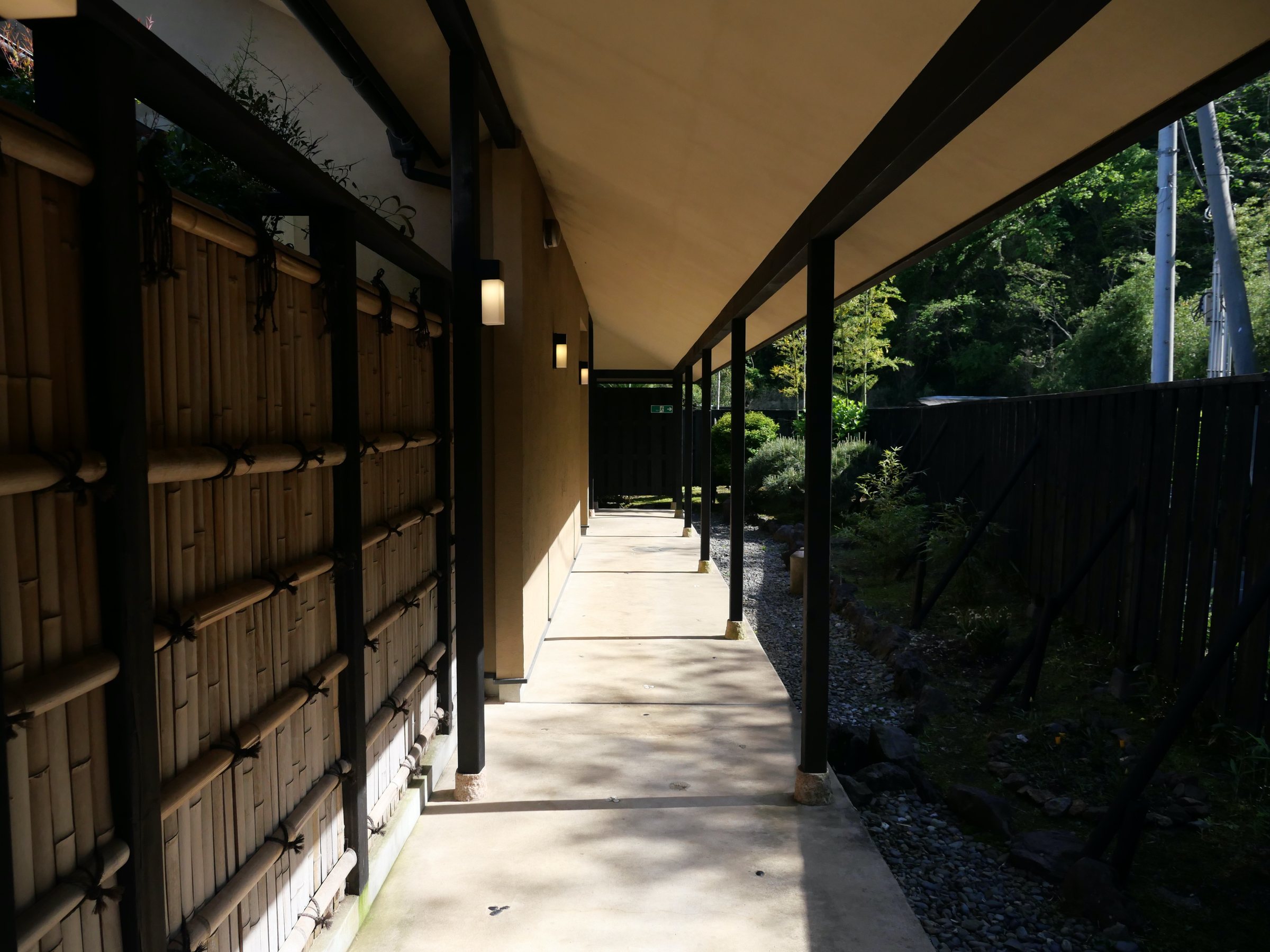 The covered walkway, lined with bamboo lattice.