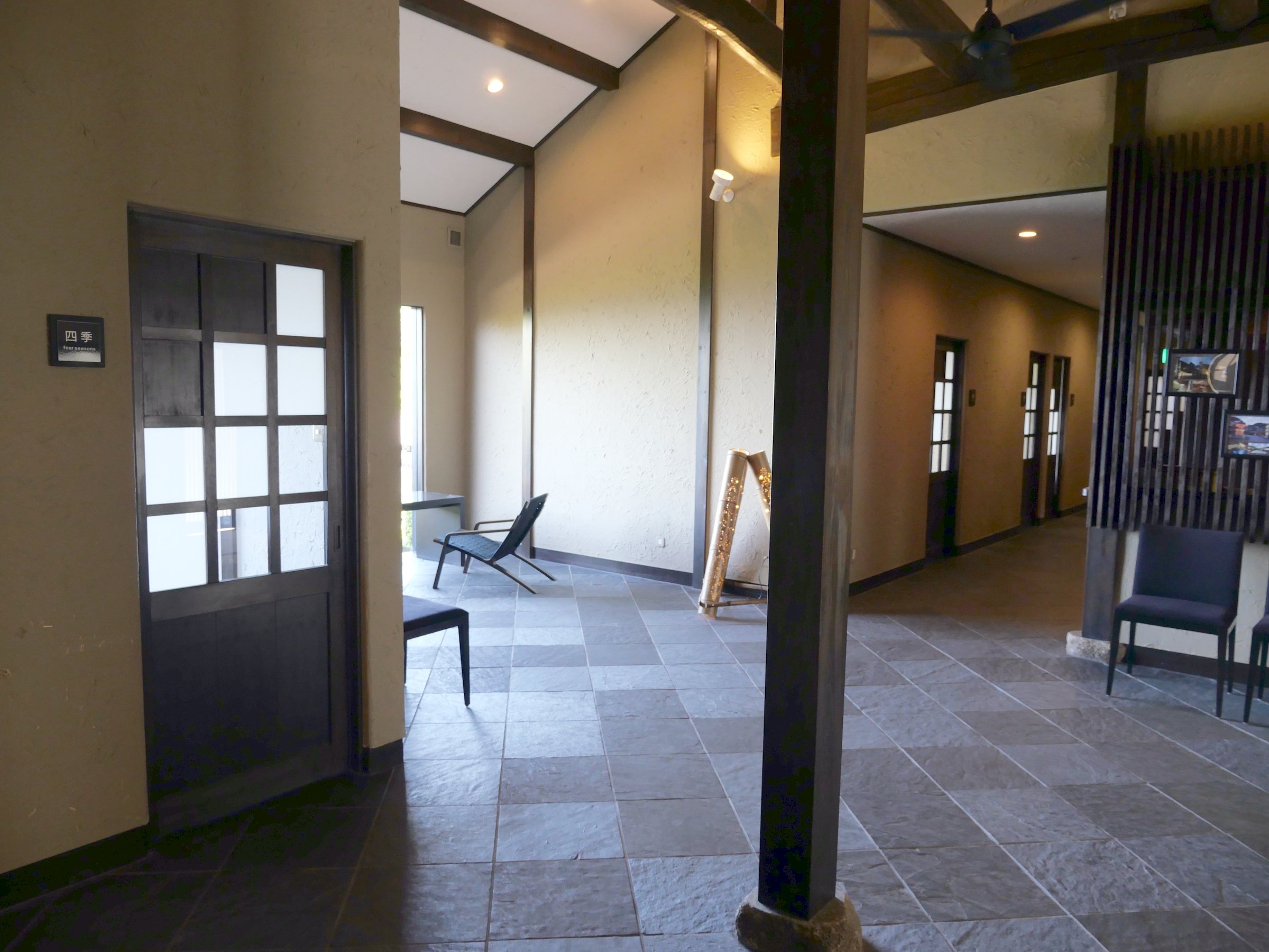 Inside the villa: slate floors, dark timber and a high, open ceiling.